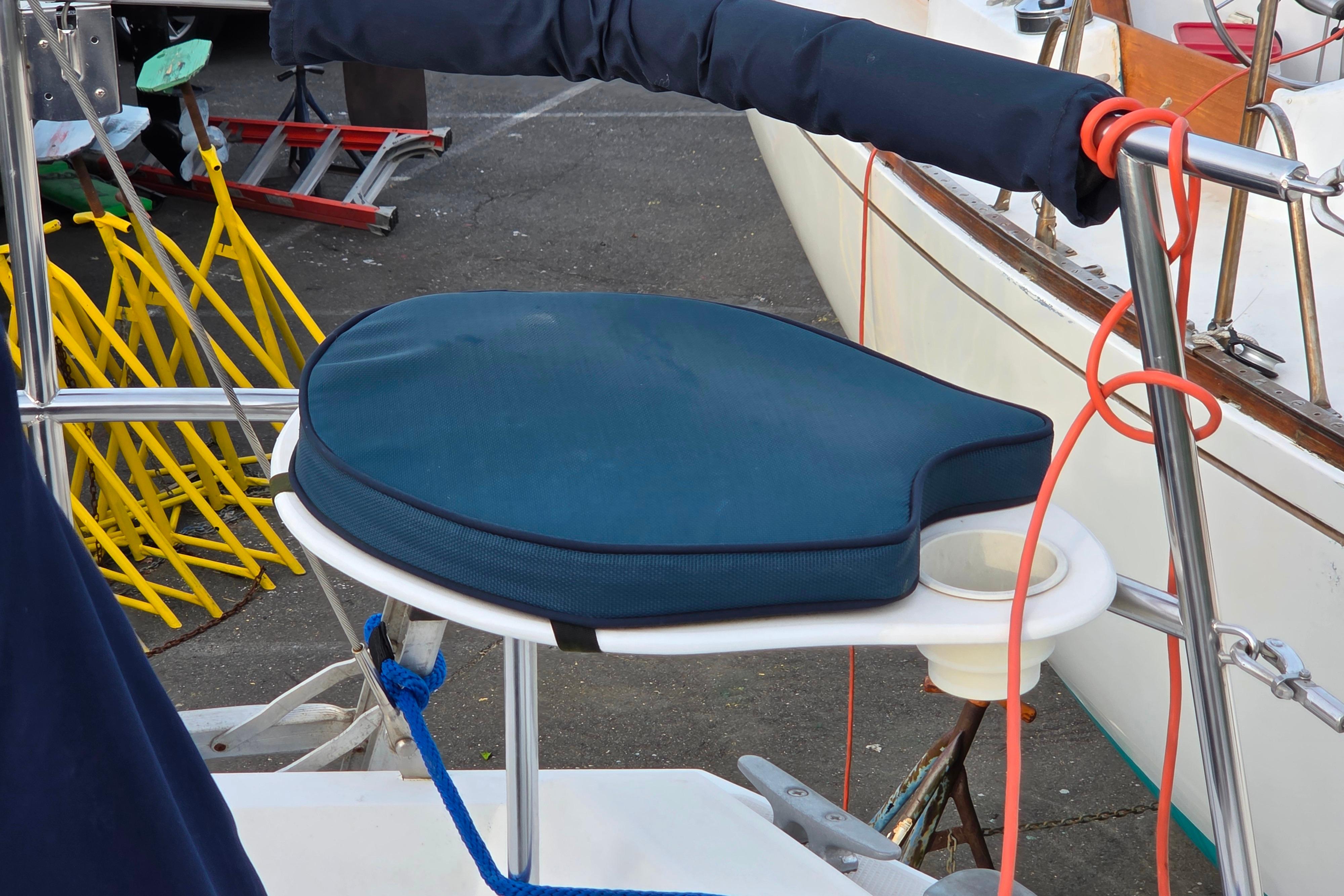 Blue cushioned seat on Catalina 355 sailboat, 1986 model, docked with nautical equipment.