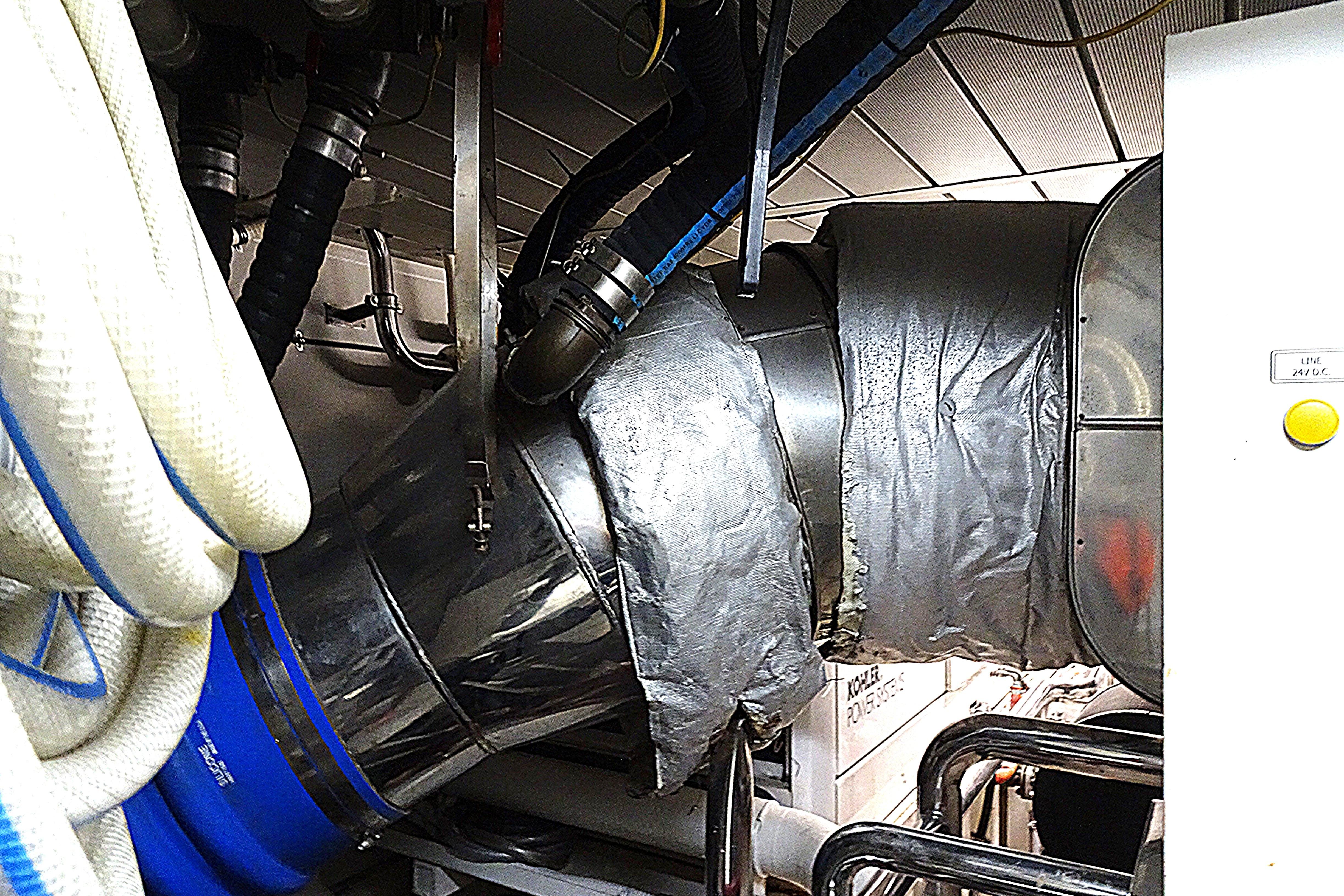 Engine room of 2010 Azimut 100 Leonardo yacht with insulated pipes and machinery.
