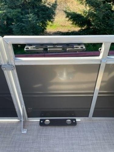 2024 Sun Tracker Fishin' Barge 20 DLX deck view with railing and rod holders.