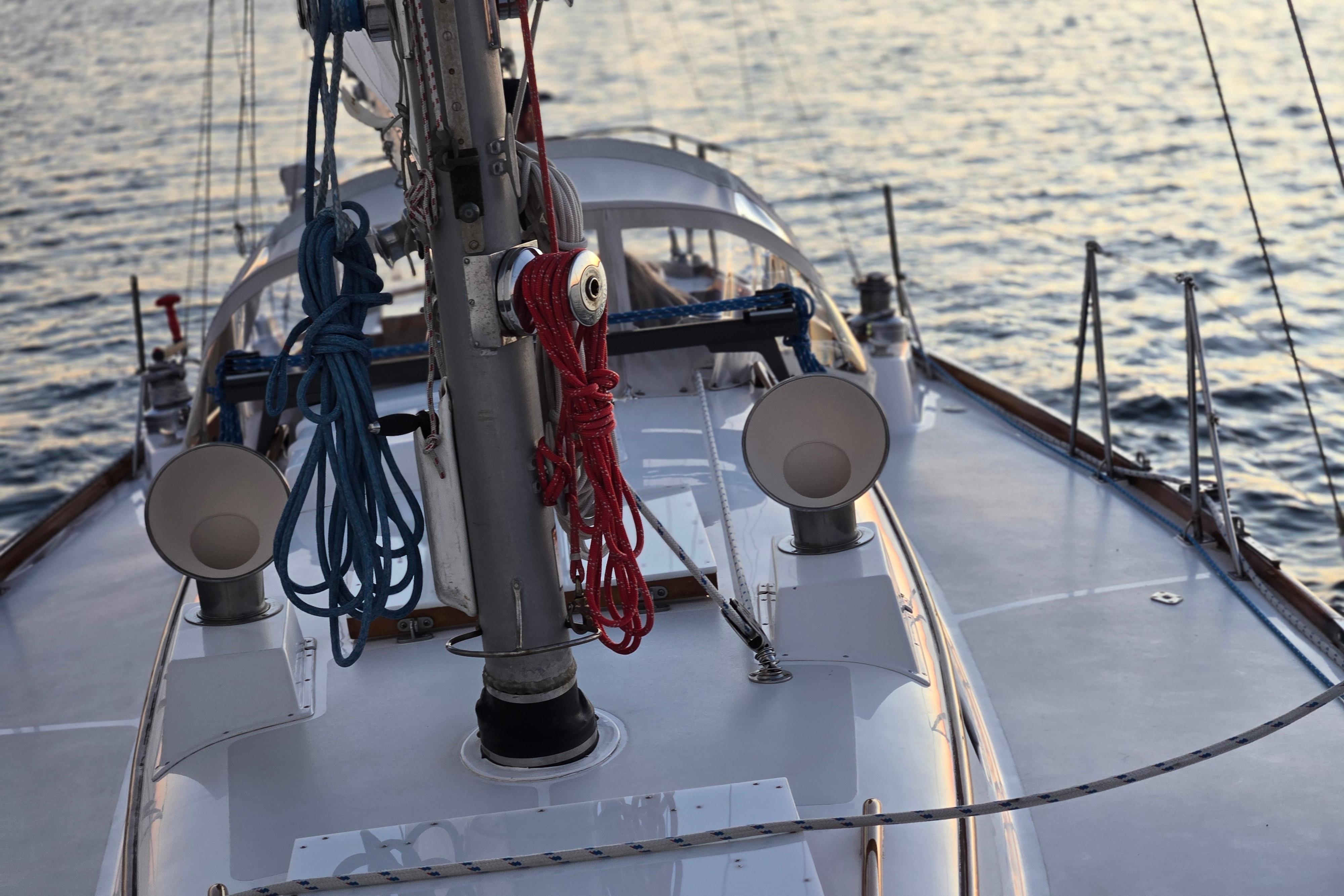 1970 Hinckley Bermuda 40 sailboat deck with ropes and ocean backdrop.