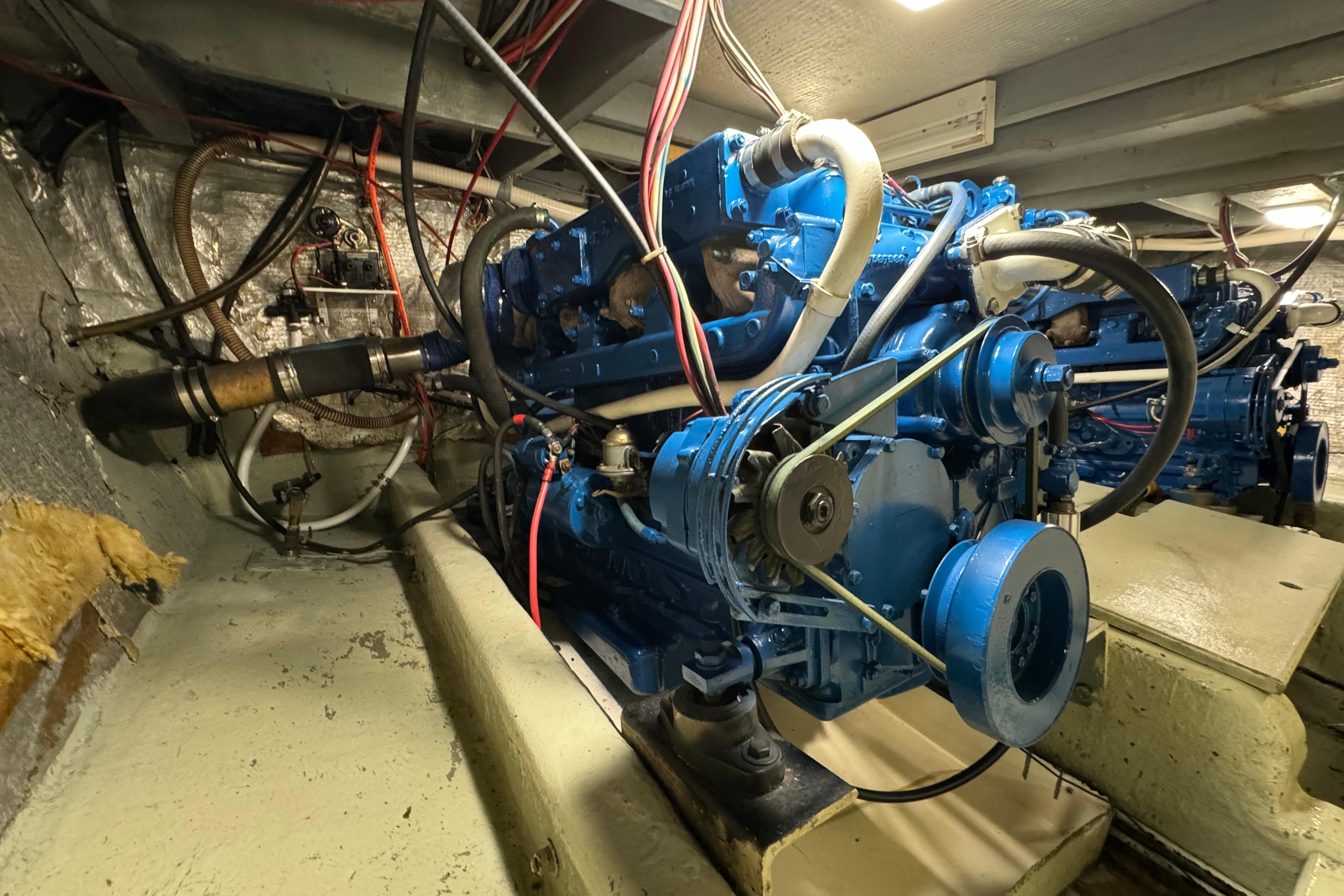 Engine room of a 1978 Californian 42 LRC boat, featuring a blue marine engine.