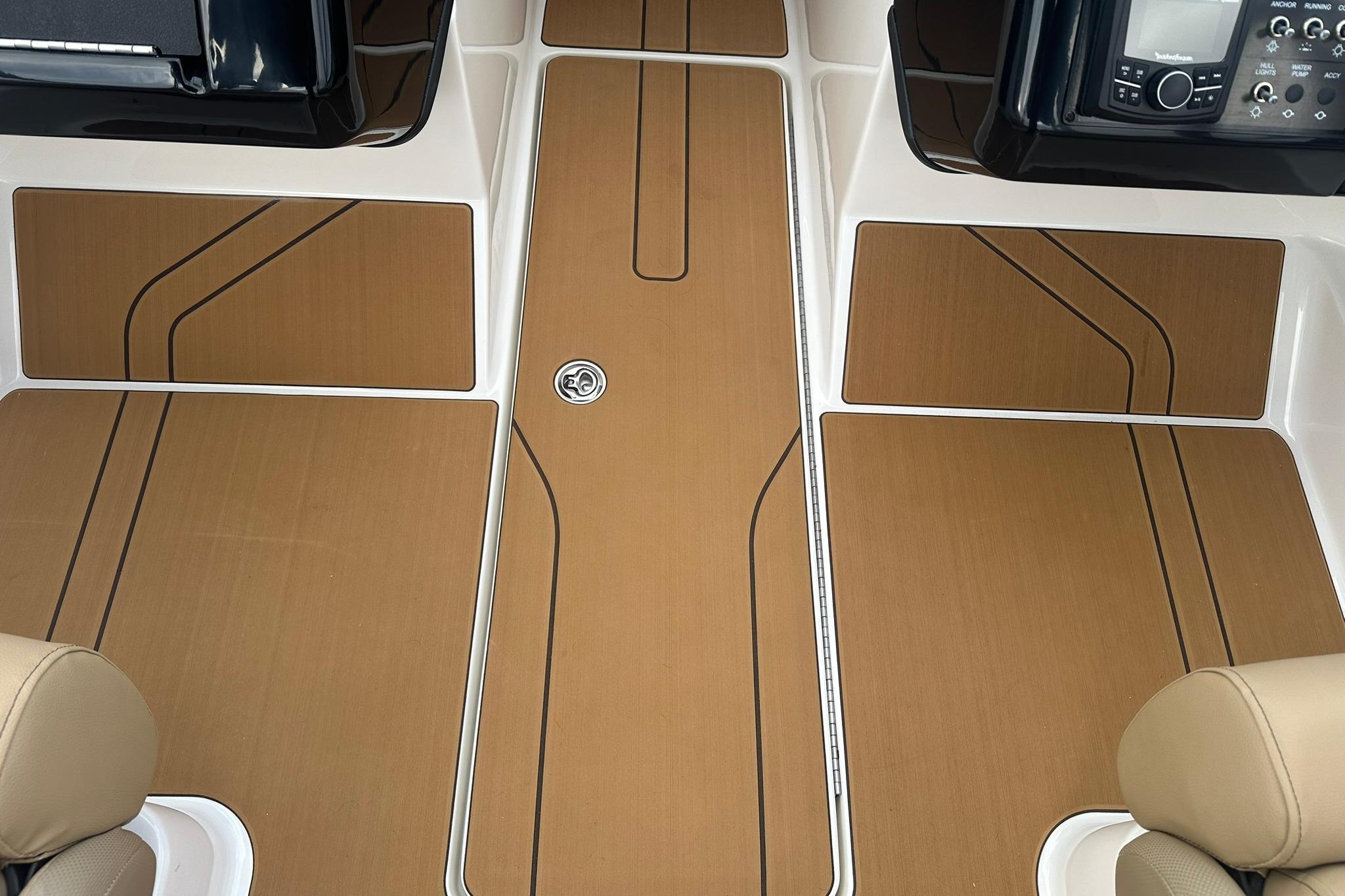 2026 Bayliner V20 boat interior with sleek brown flooring and modern dashboard.