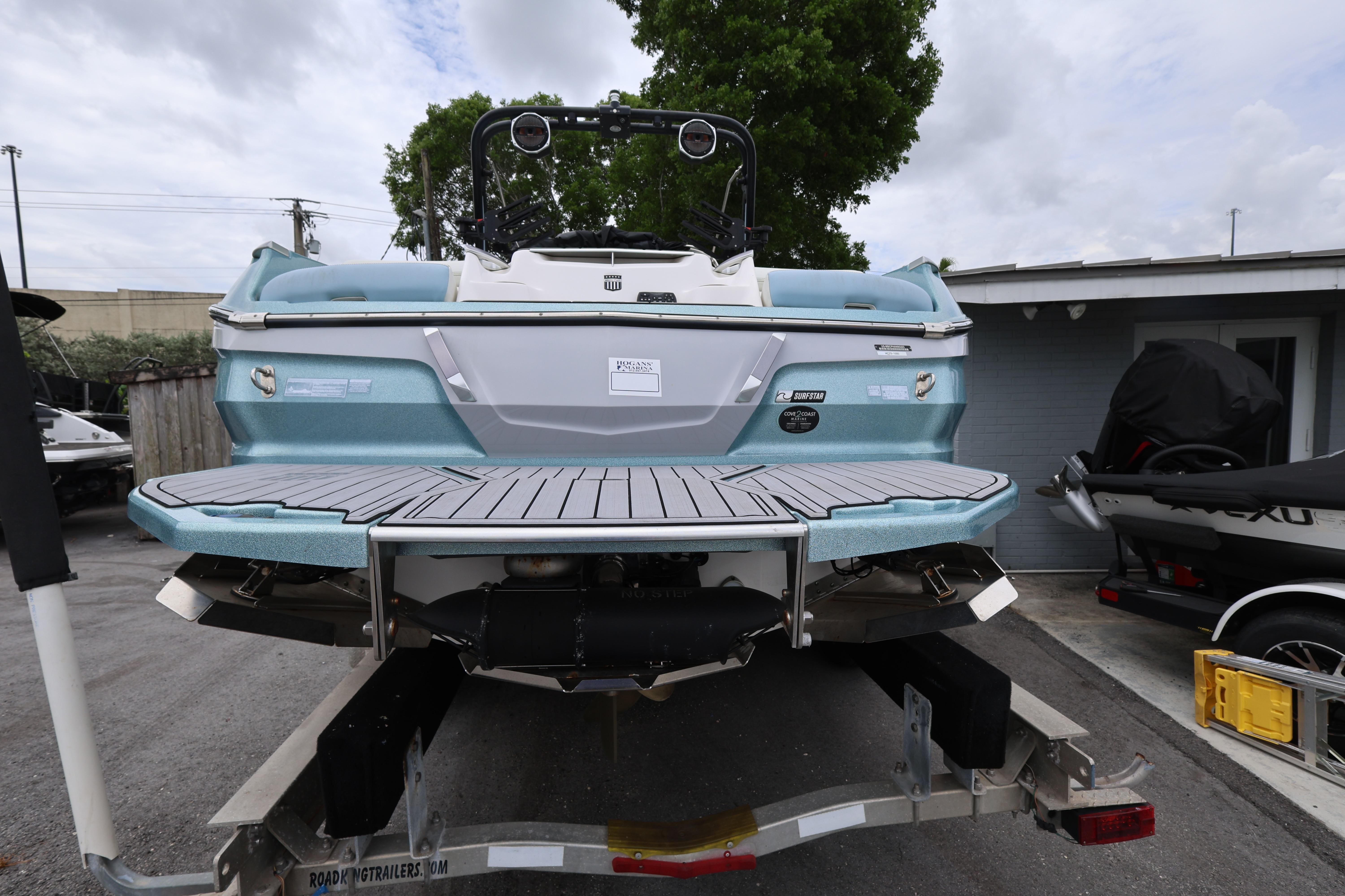 2023 MasterCraft X24 boat on trailer, rear view, showcasing sleek design and modern features.