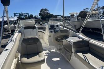2022 Key West 239 DFS boat interior with seating and control panel in a marina.