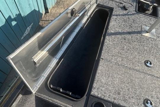 Open storage compartment on 2026 Tracker Pro Team 195 boat deck.