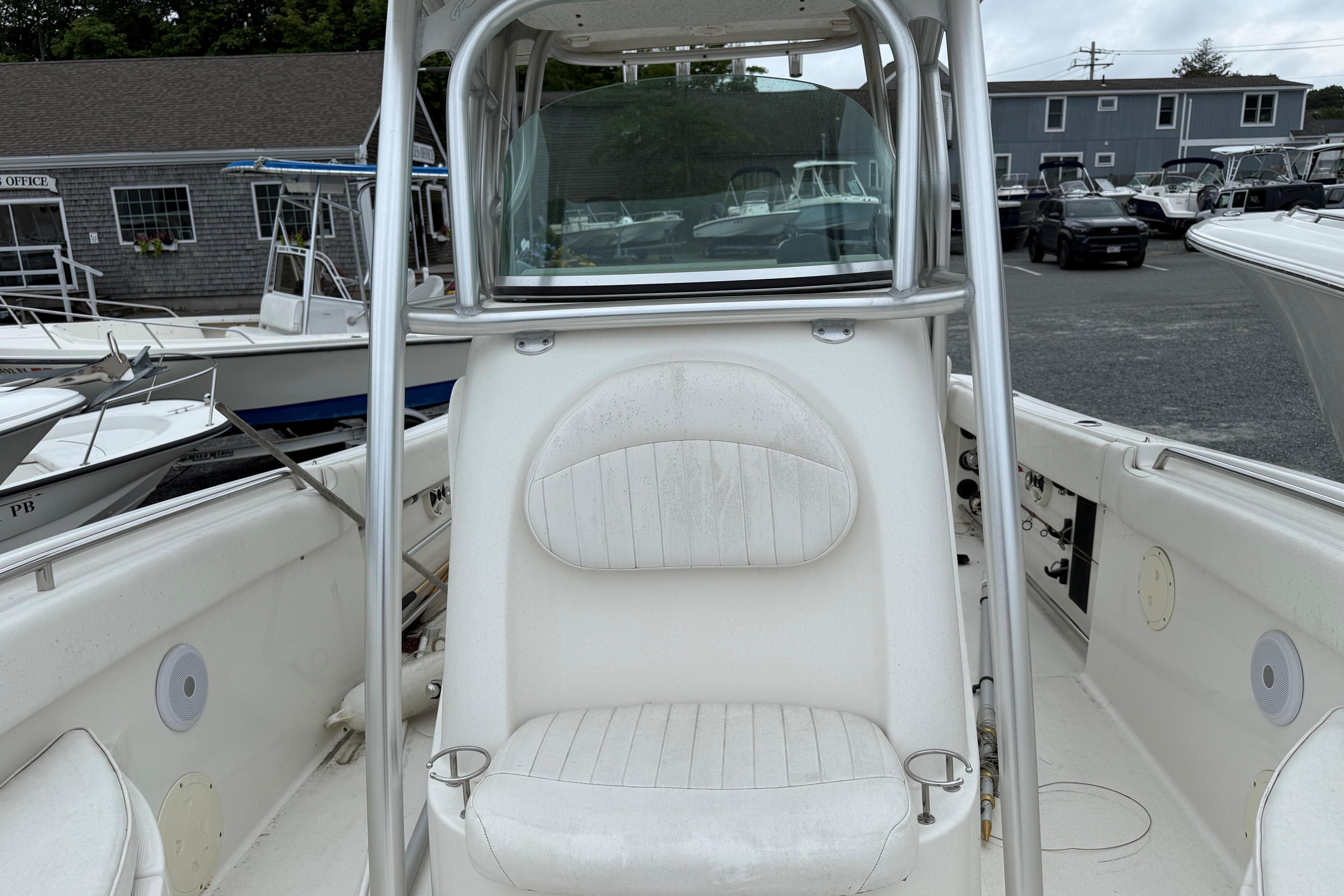 2009 Robalo R240 Center Console boat with white seating and stainless steel frame.