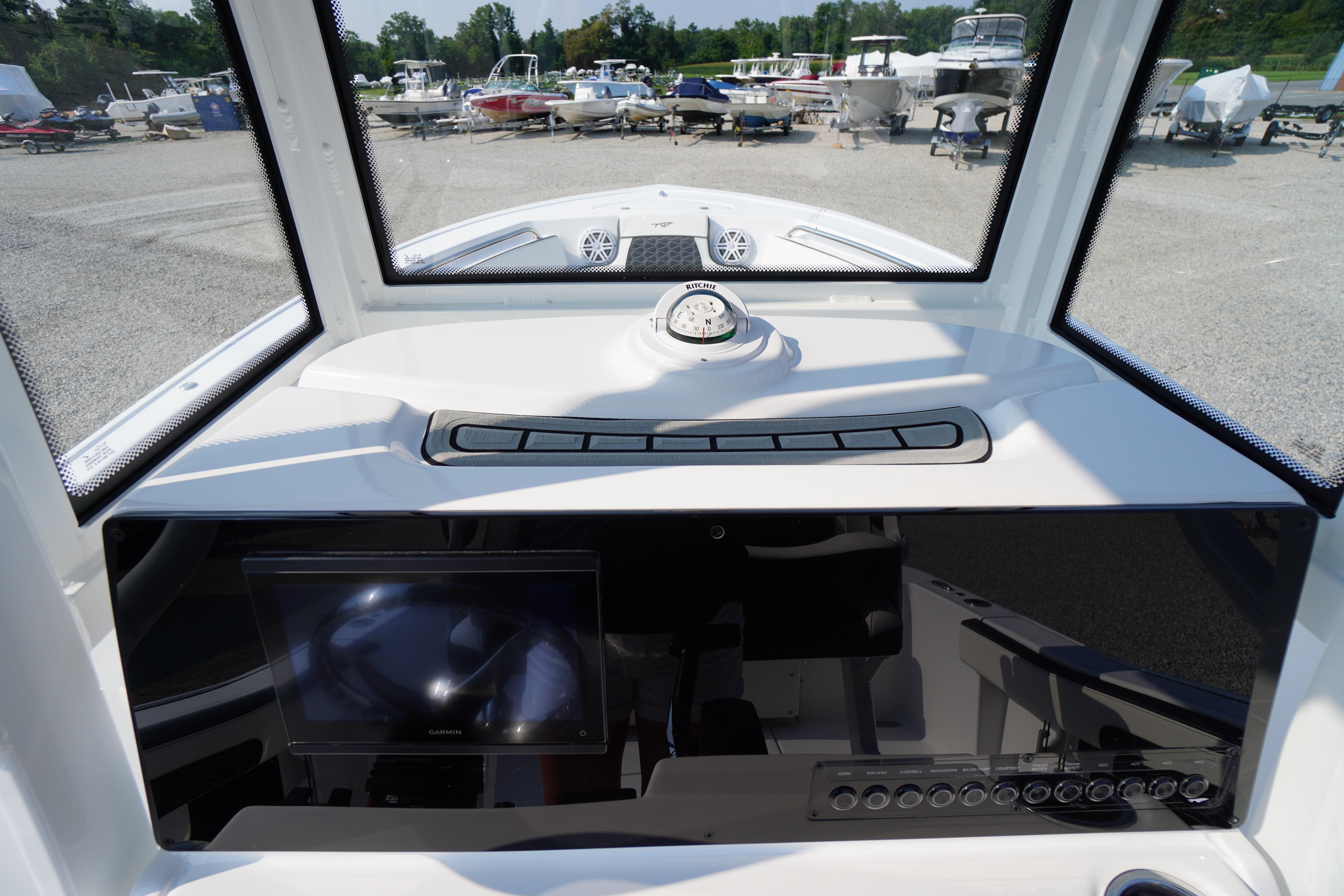 2026 Tidewater 210 CC Adventure boat dashboard with compass and navigation screen.