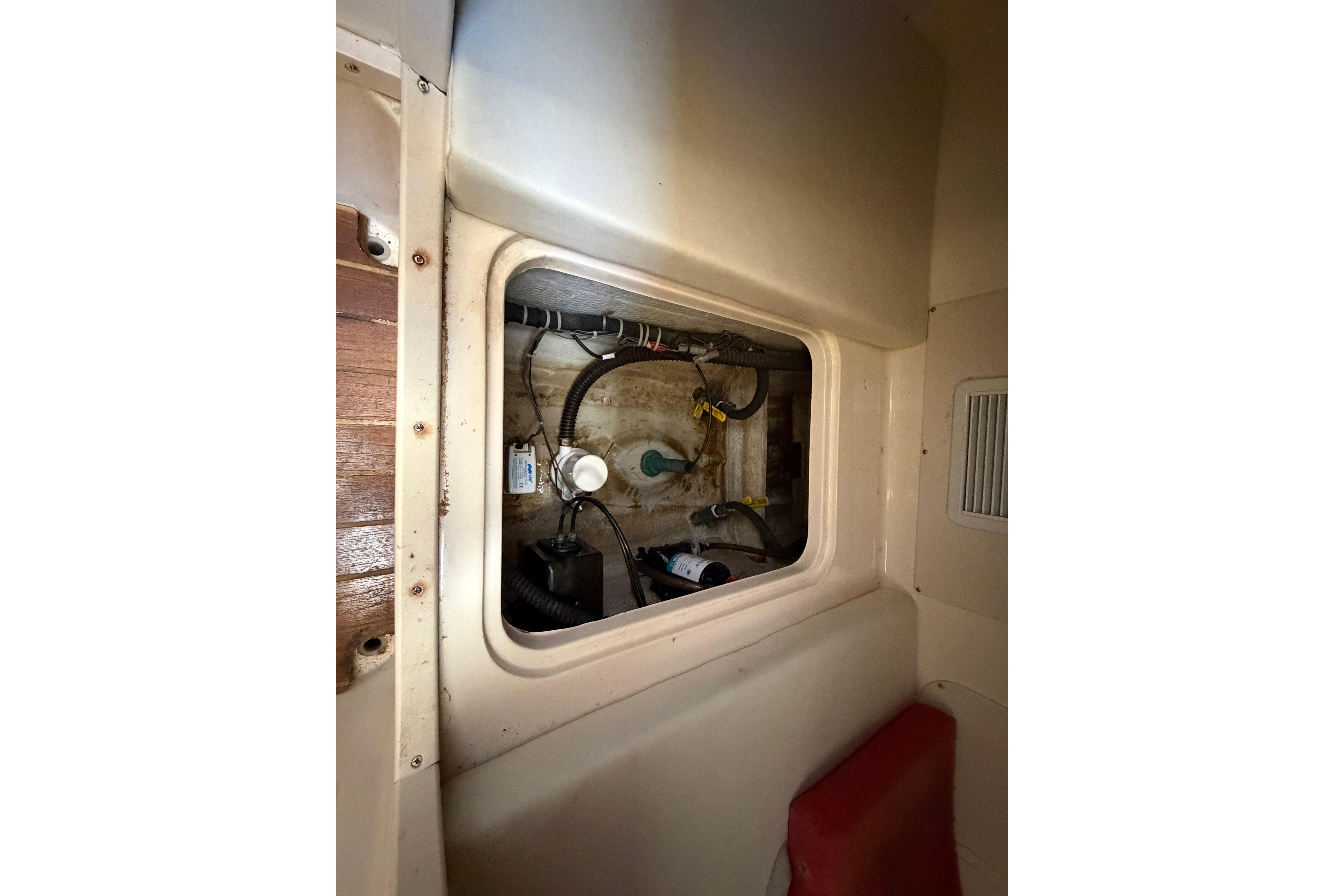 2006 Grady-White Sailfish 282 interior compartment with visible wiring and components.
