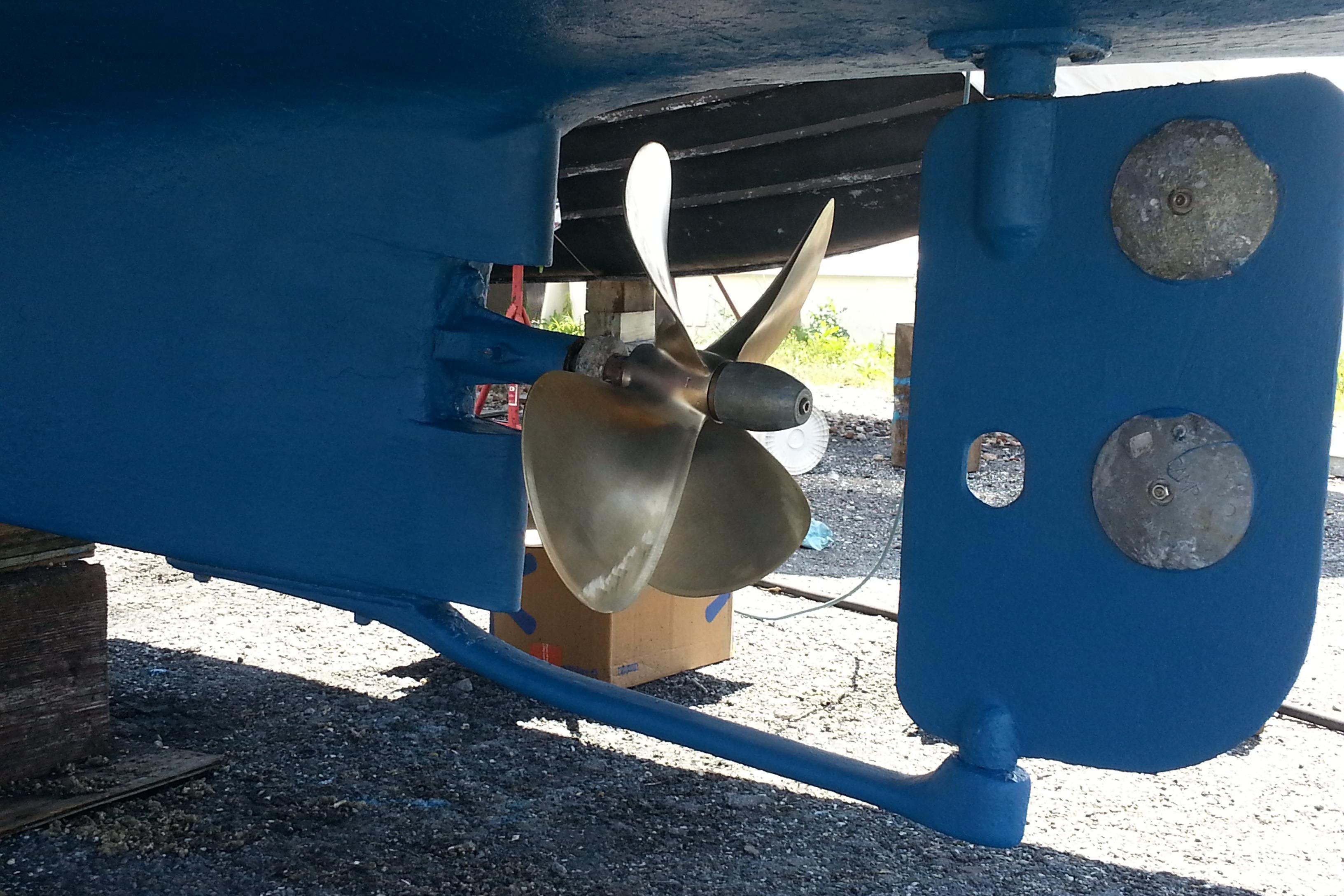 1979 Mainship 34 Custom Sedan boat propeller and rudder, painted blue, on dry dock.