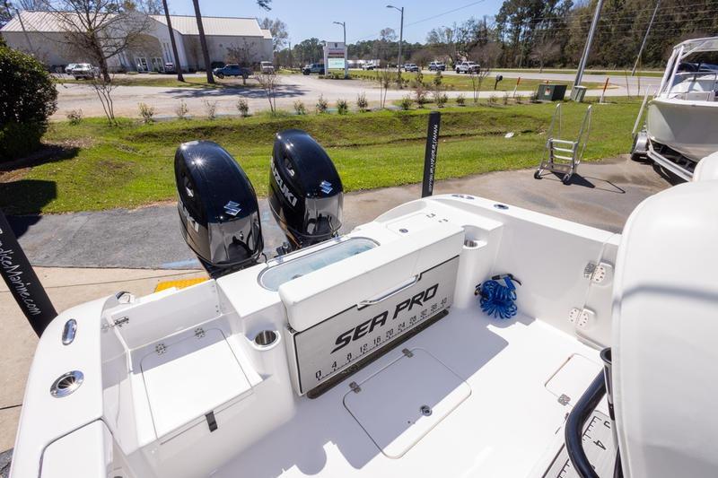 2025 Sea Pro 262 Offshore boat with dual Suzuki engines, parked outdoors.