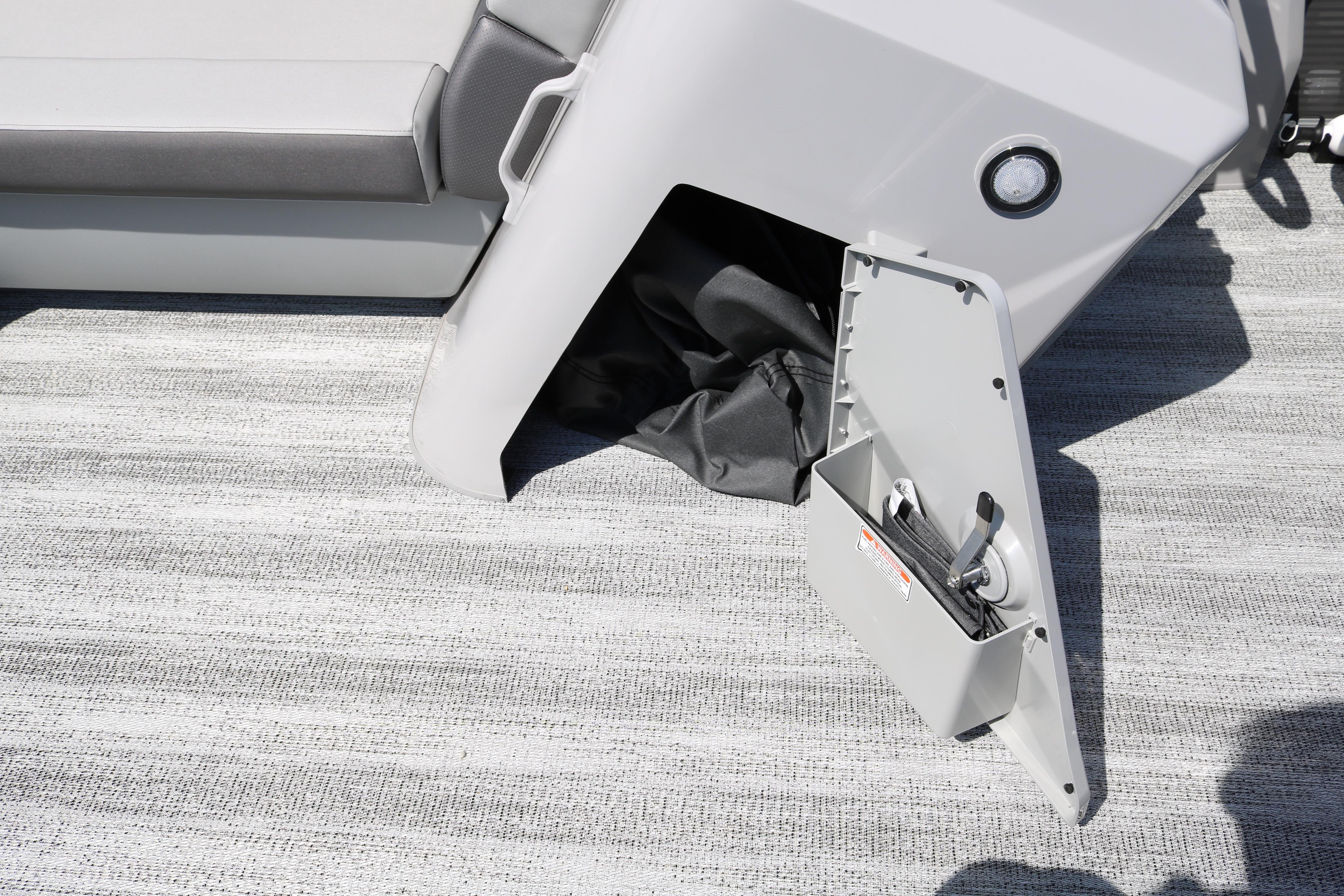 Open storage compartment on 2026 Bennington 20SXSNP REAR FISH boat, showing interior details.