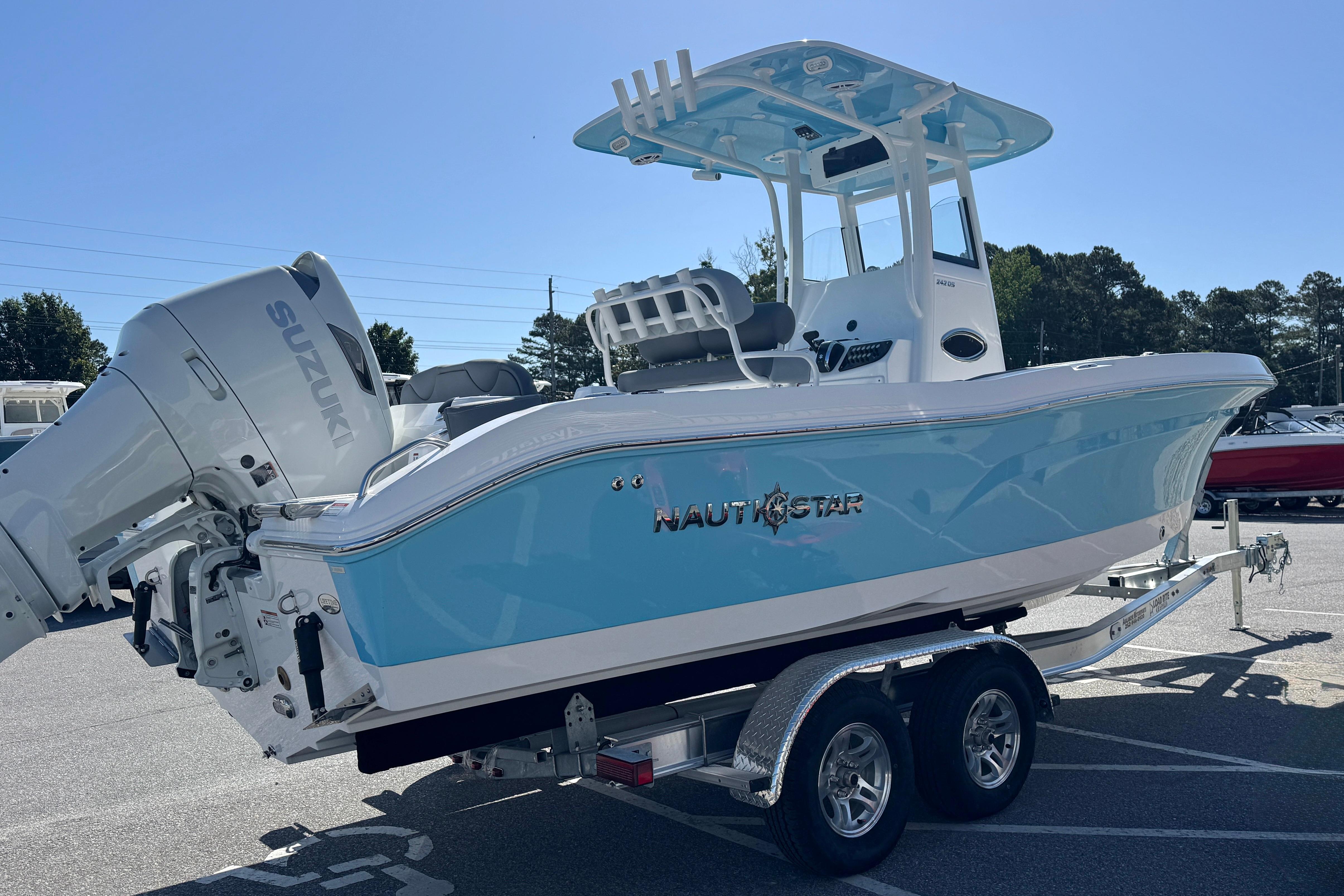 2026 NauticStar 242 Offshore boat with Suzuki engine on trailer.