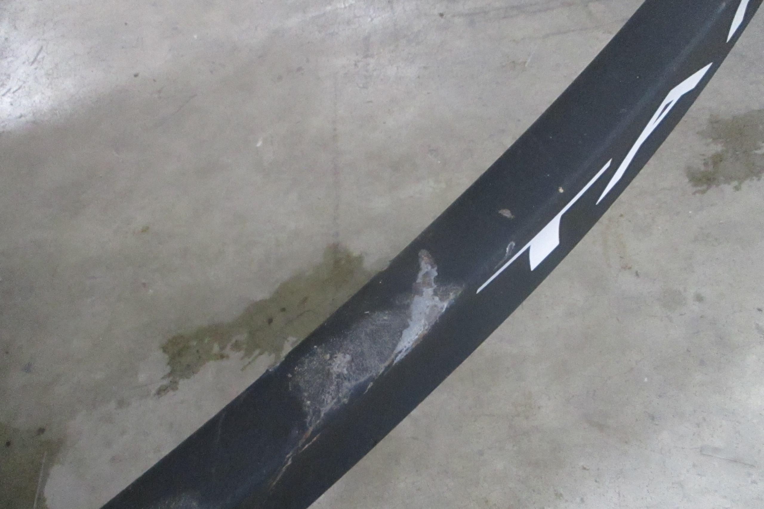 Close-up of a 2025 Tahoe T18 tire with visible wear on concrete floor.