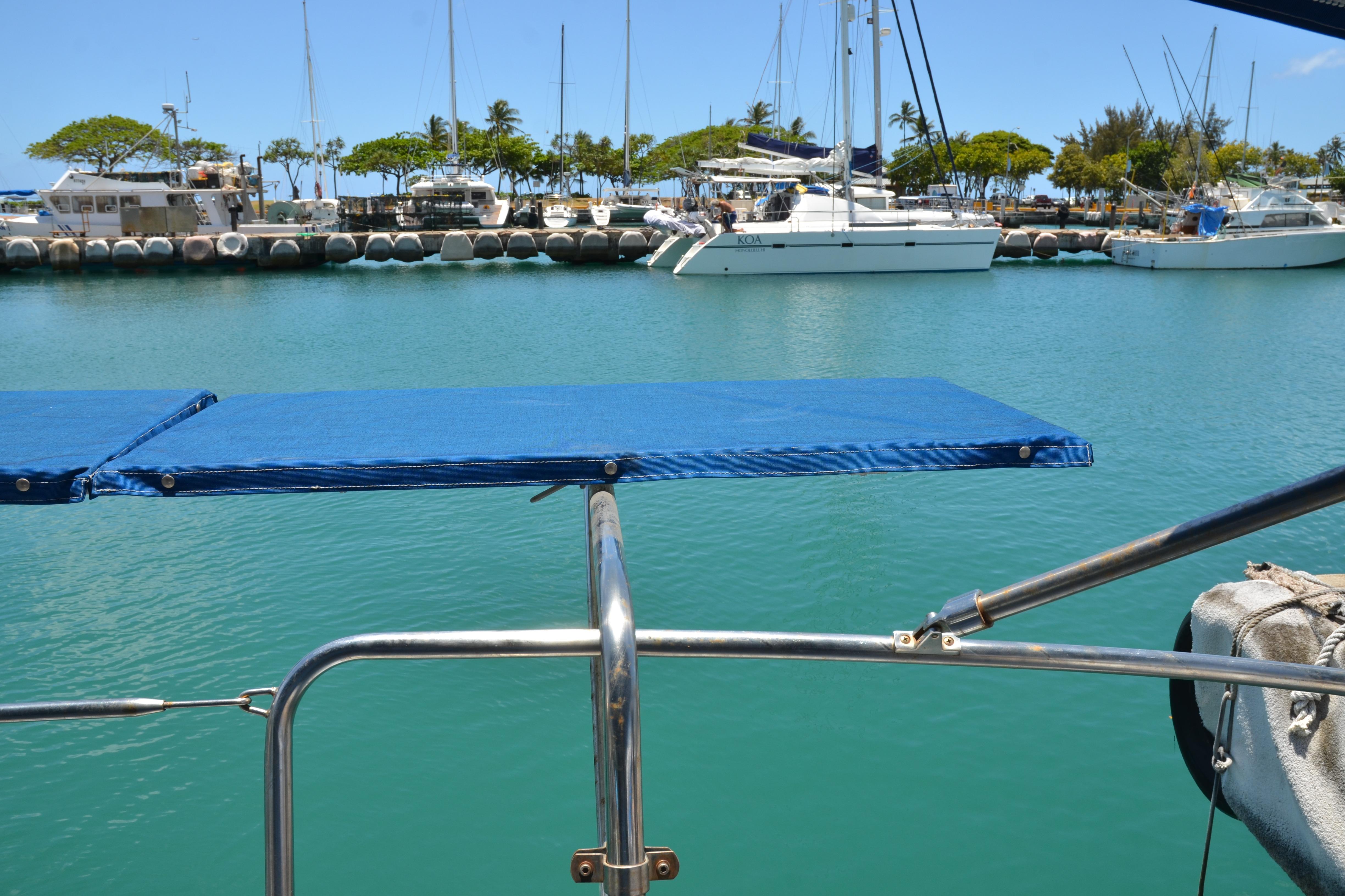 Marina view from 1987 Norseman 400 sailboat, featuring calm waters and docked boats.