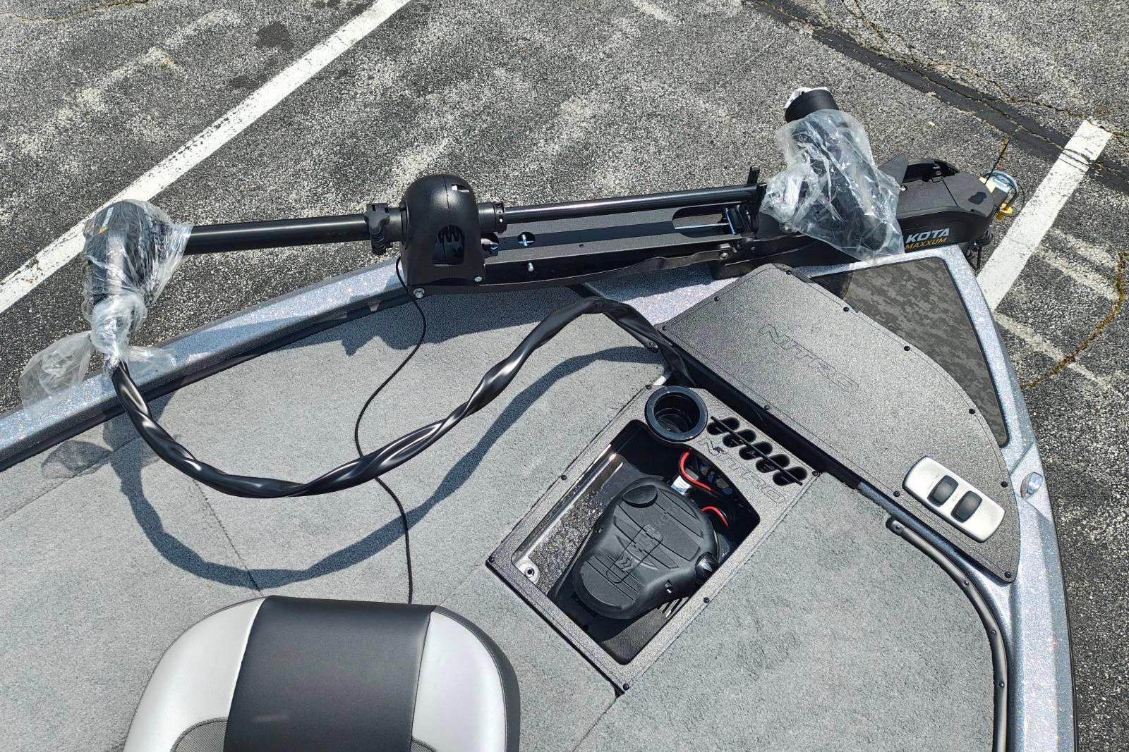 2026 Nitro Z19 XL boat deck with trolling motor and control panel in parking lot.