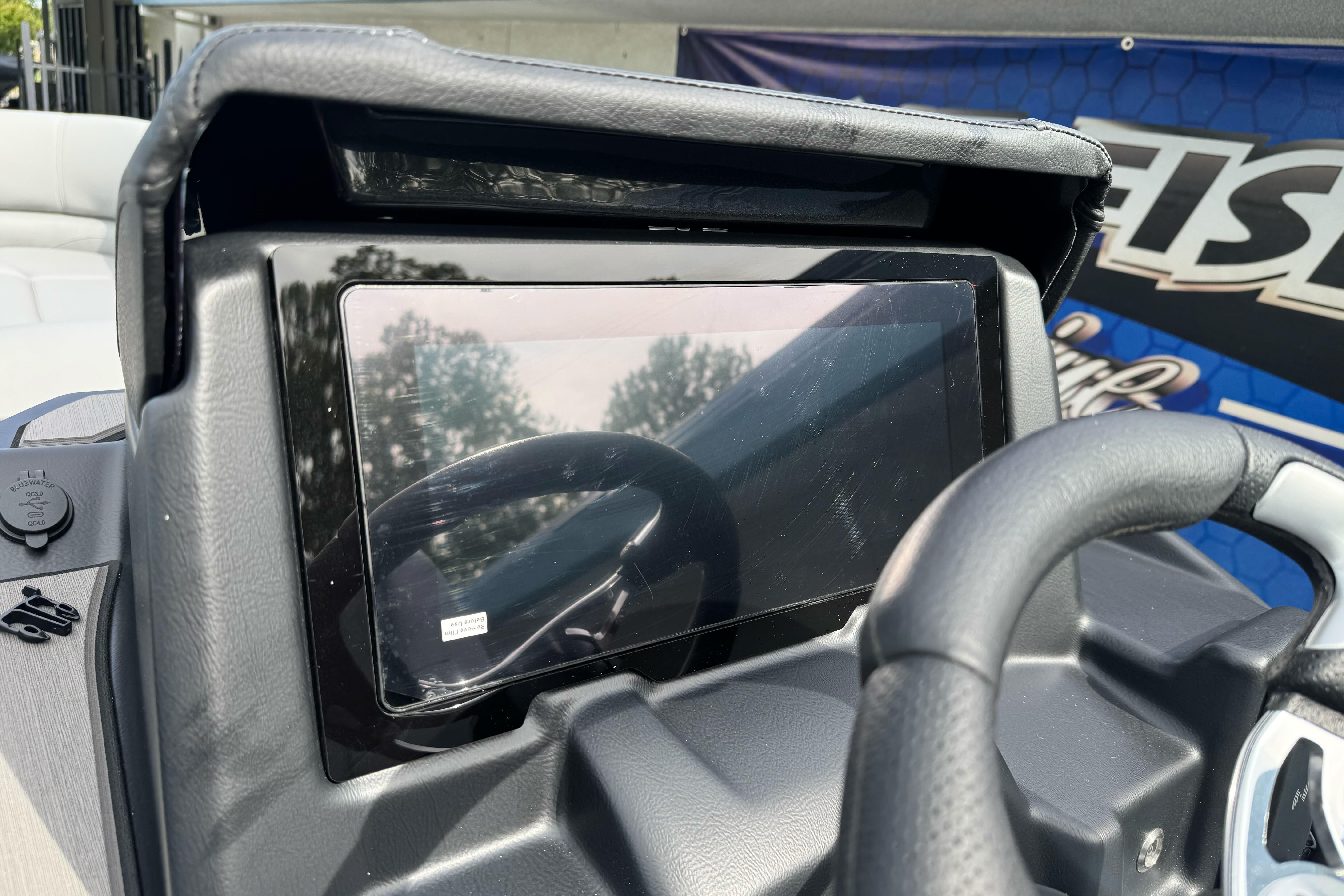 Dashboard of 2026 Regency 250 DL boat with steering wheel and display screen.