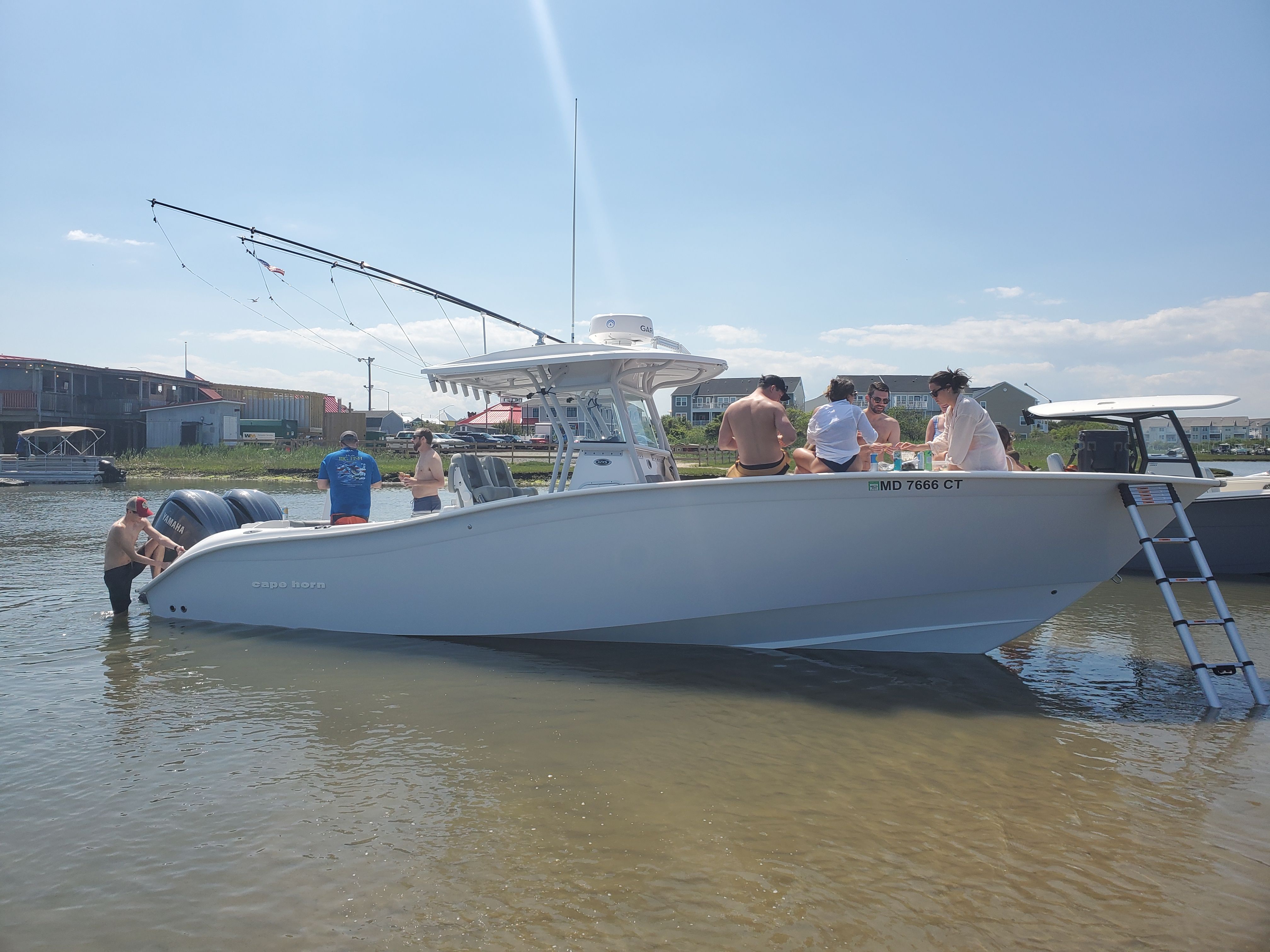 2021 Cape Horn 32 XS boat with people in the water.