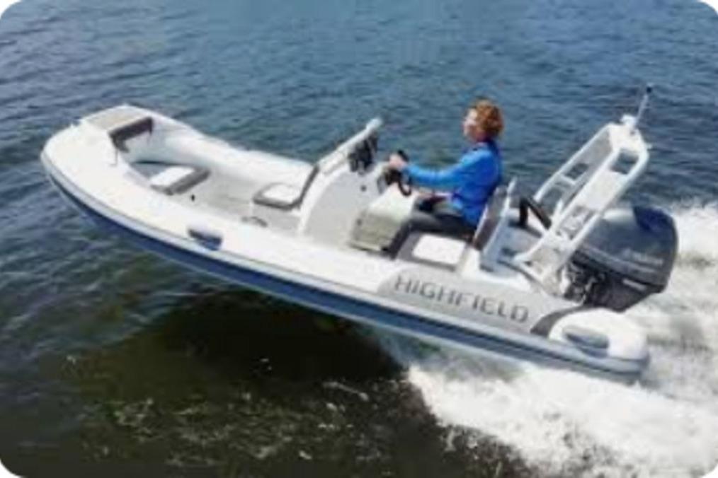 2025 Highfield Sport 420 boat cruising on water with driver in blue jacket.