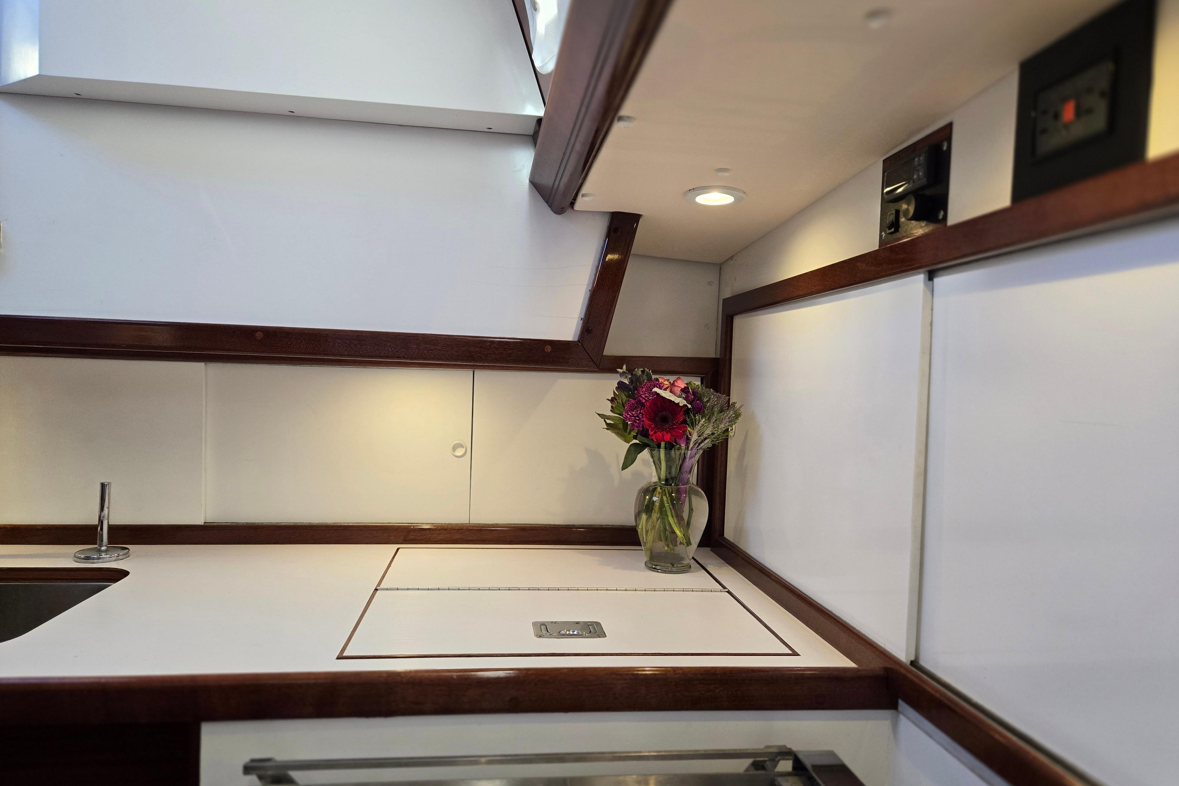 Interior of a 1970 Hinckley Bermuda 40 yacht with a vase of flowers.