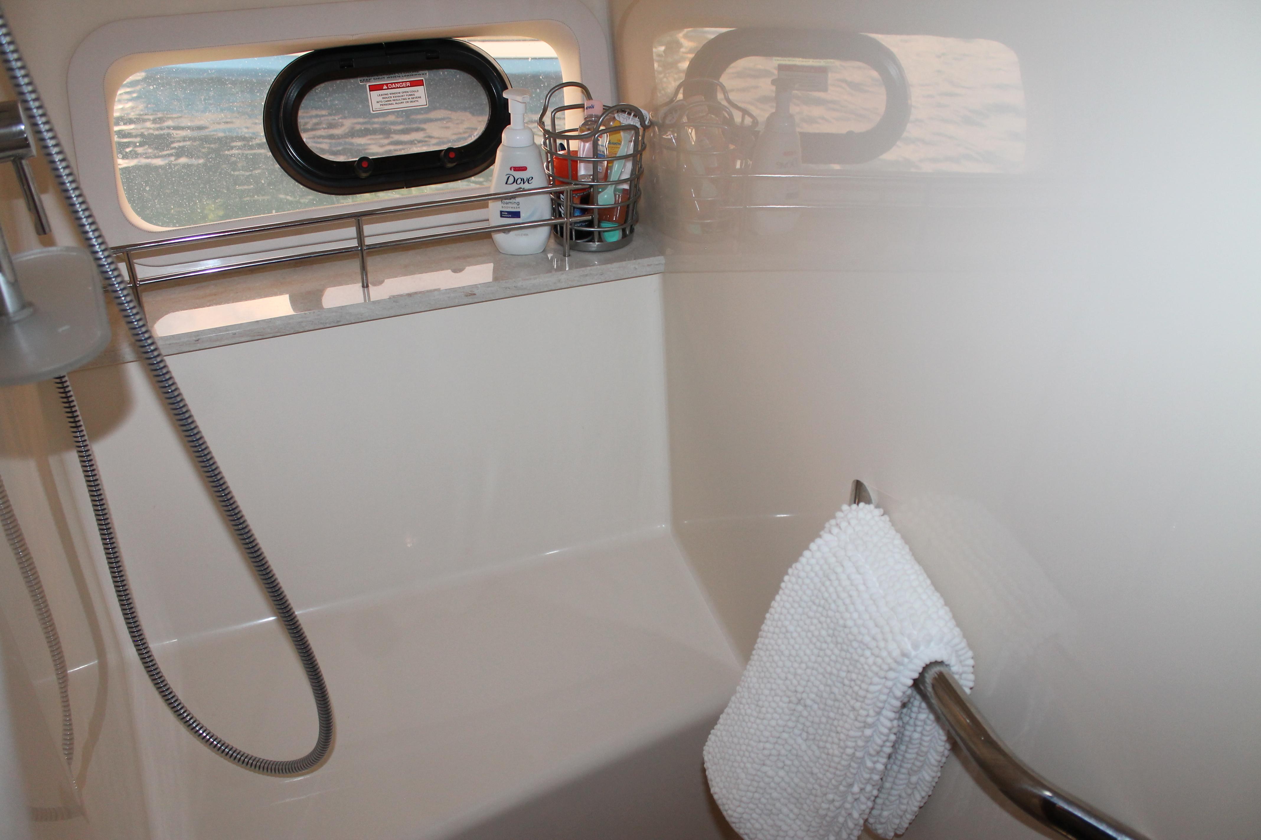 2015 Sea Ray 470 Sundancer bathroom with shower, towel, and window view.