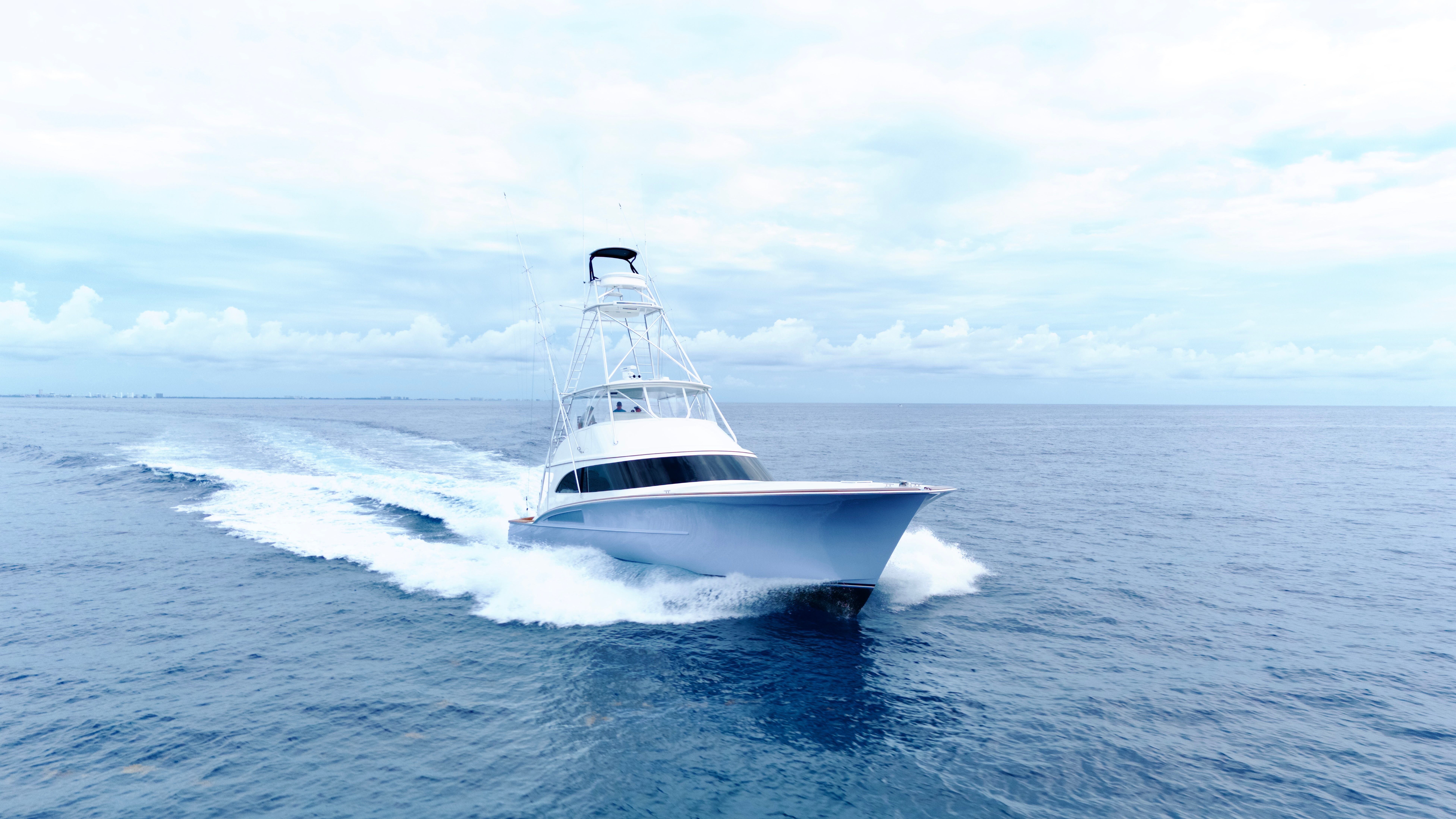 A 2025 Titan Yachts sportfish boat speeding across the open sea.