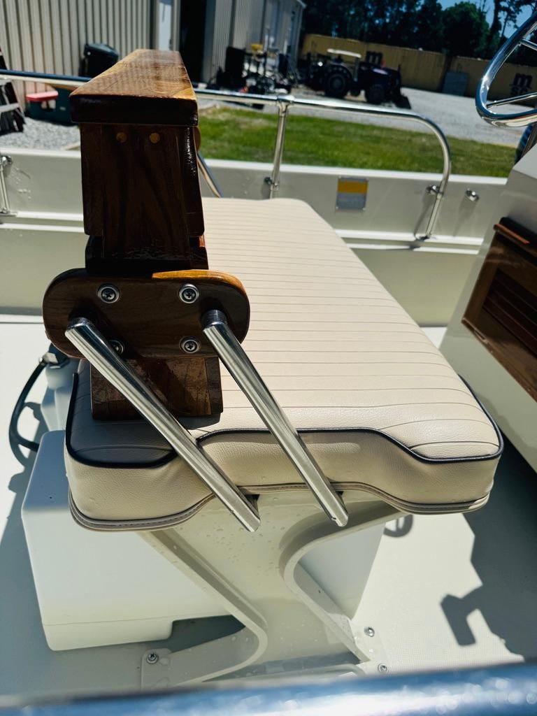 Close-up of a cushioned bench seat with metal supports on a 1986 Boston Whaler 17 Montauk.