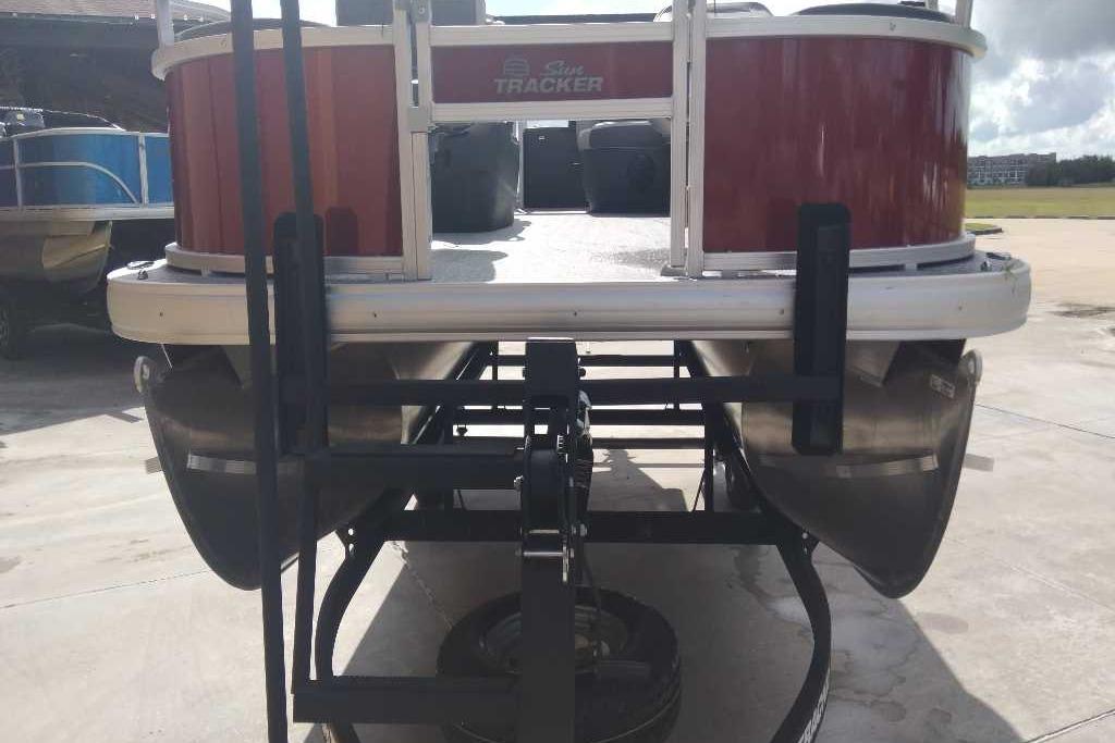 2026 Sun Tracker Bass Buggy 18 DLX pontoon boat on trailer, rear view.