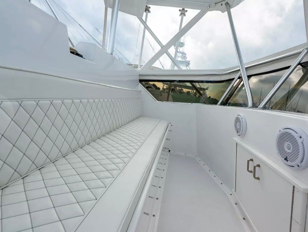 Interior of a 1979 Hatteras sport fishing boat with cushioned seating and speakers.