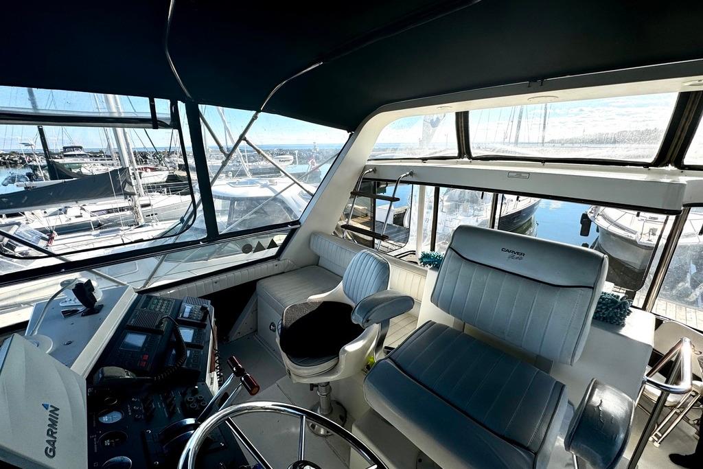 Interior view of 1991 Carver 430 Cockpit Motor Yacht with marina background.