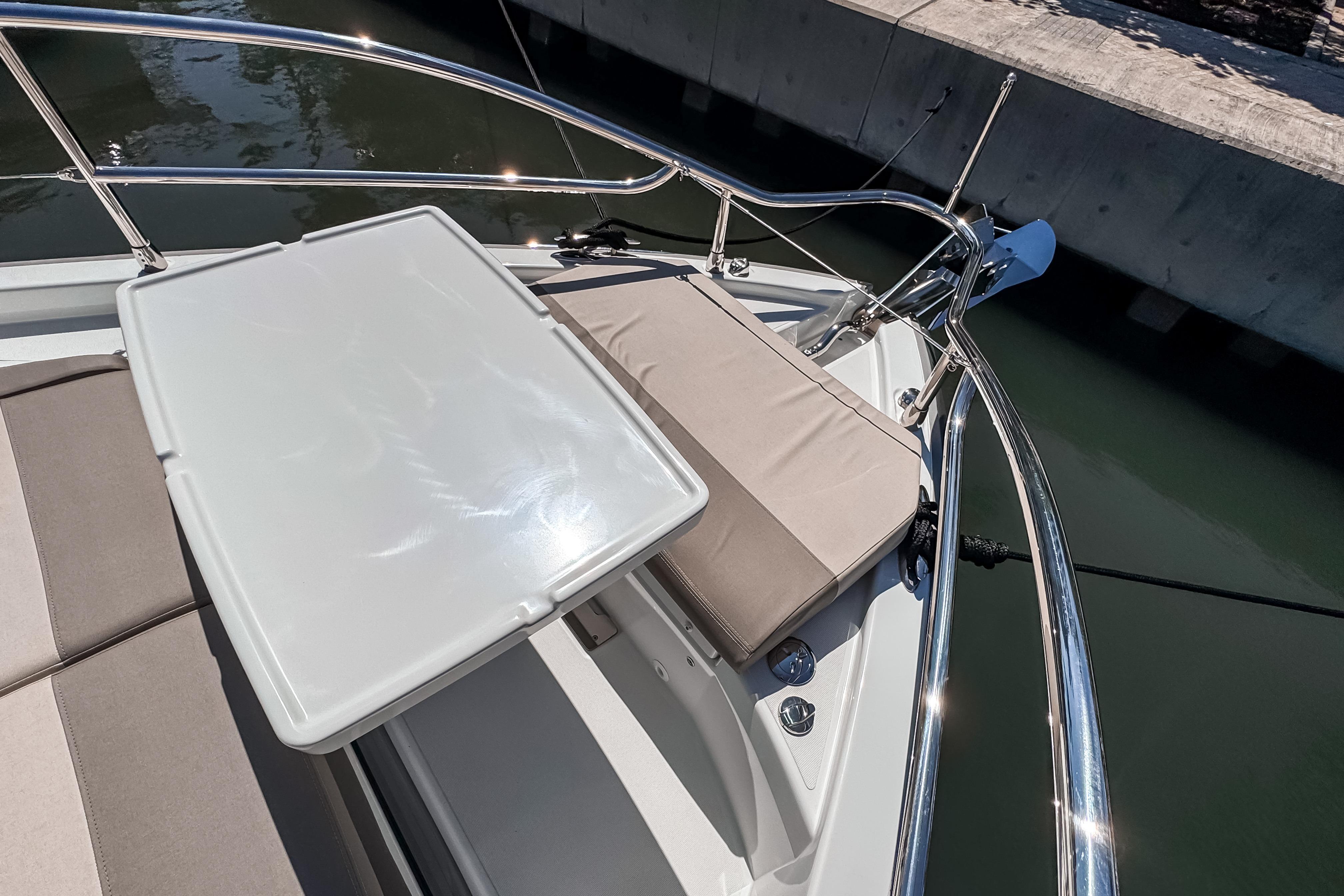 Wellcraft 44 Explorer 2026 bow area with table and cushion seating.