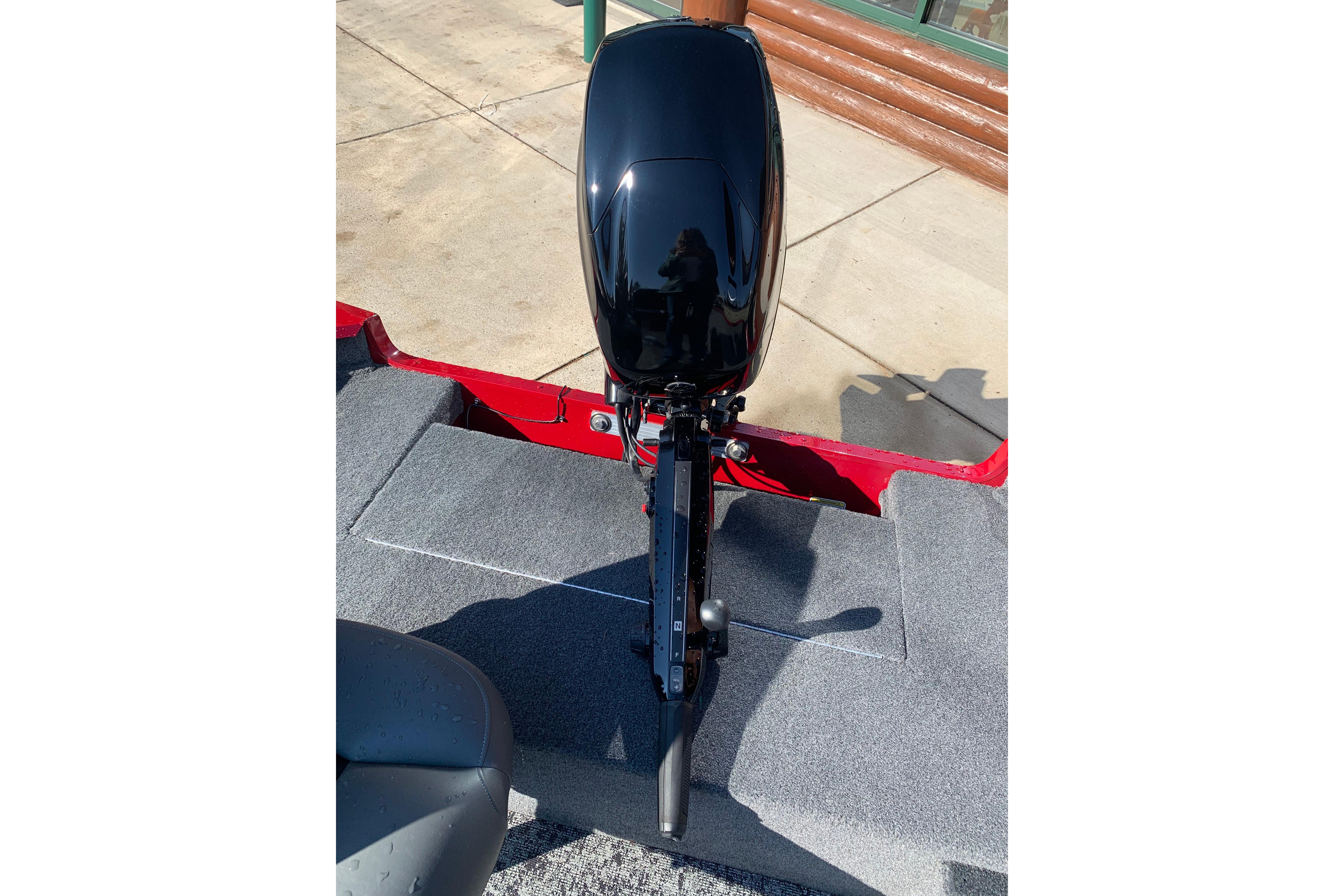 2025 Tracker Super Guide V-16 T boat with sleek black motor on gray carpeted deck.