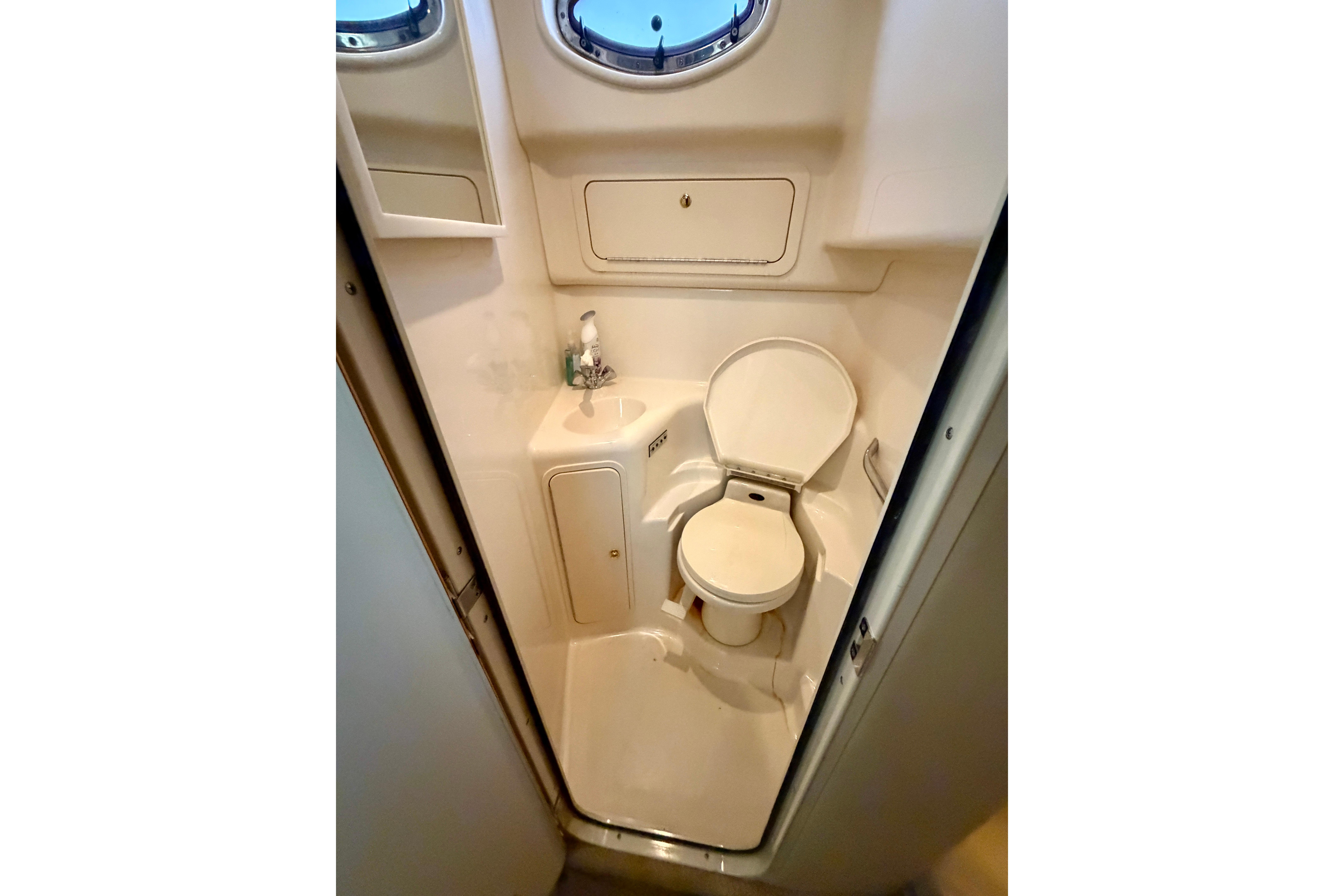 1999 Sea Ray 400 Sundancer yacht bathroom with toilet and sink.