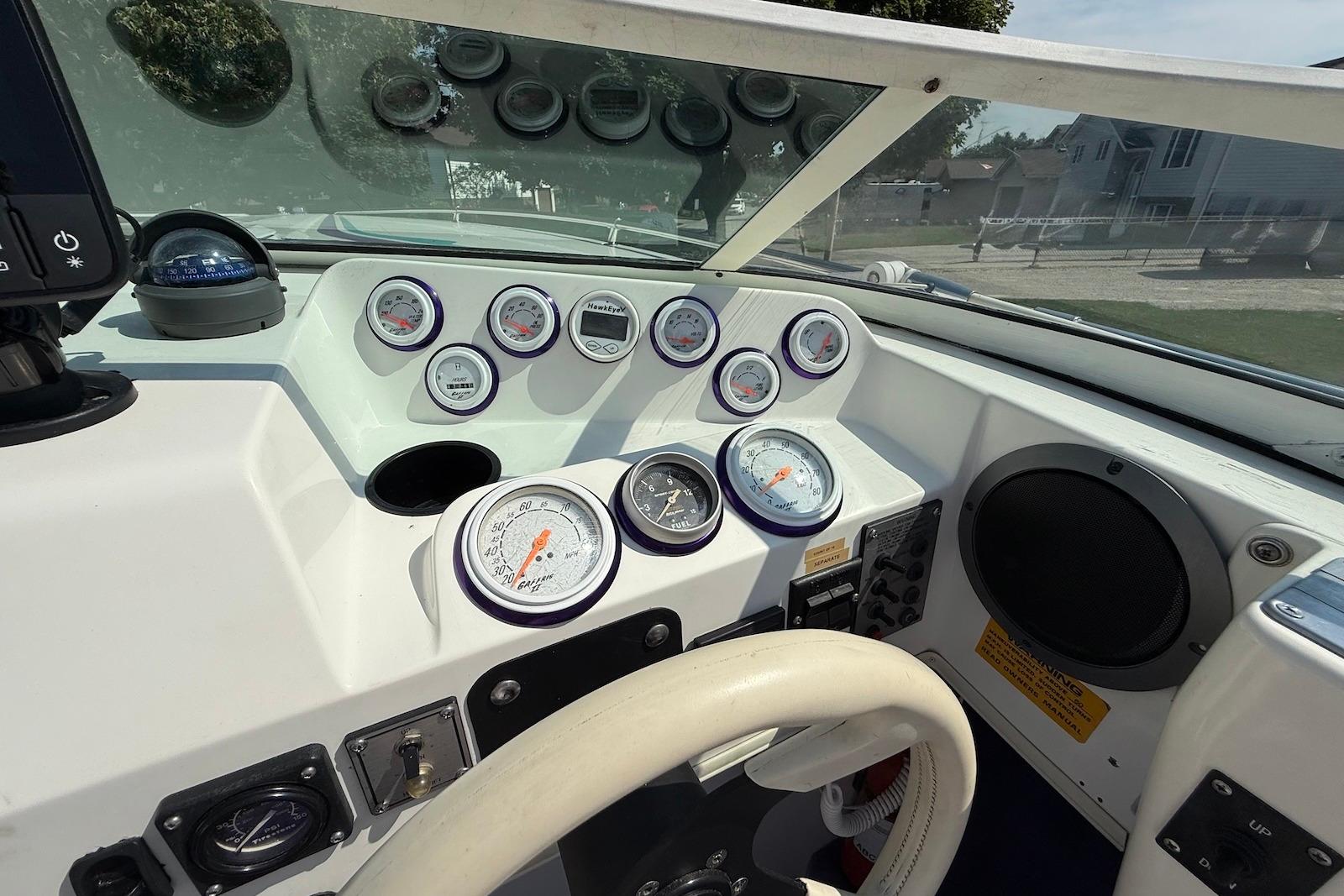 Dashboard of a 1995 Checkmate Persuader 261 boat with gauges and controls.