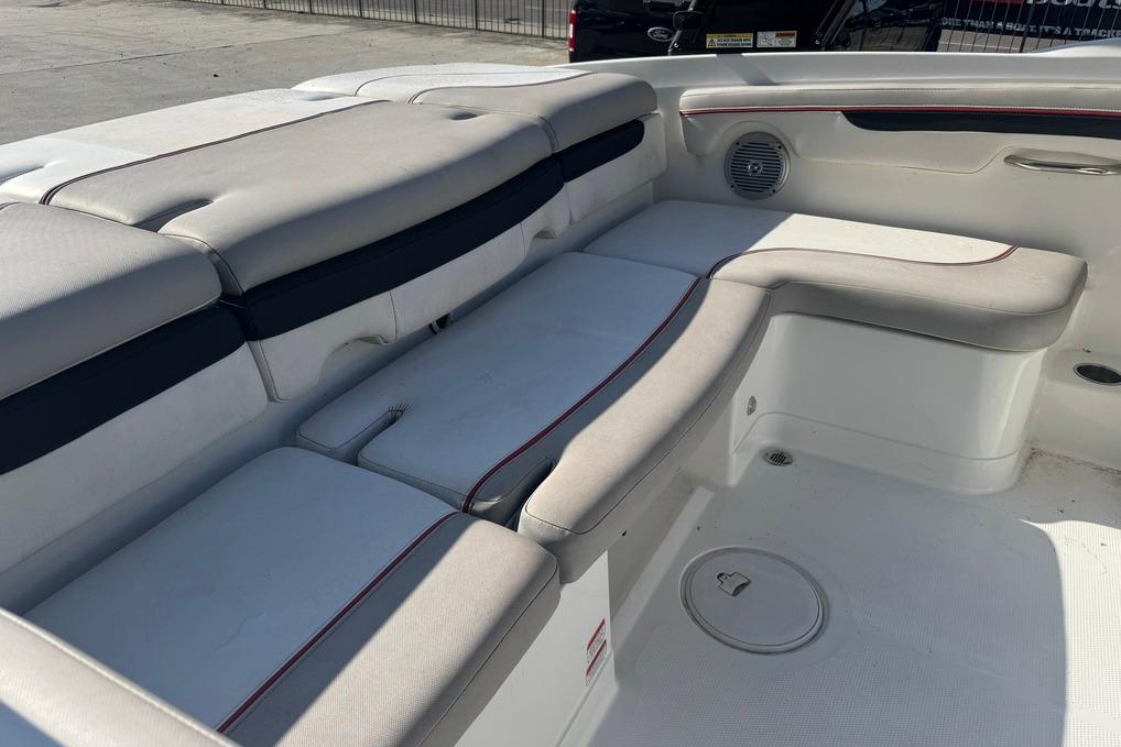 Interior seating of a 2018 Tahoe 700 TF boat, featuring cushioned benches and speaker.
