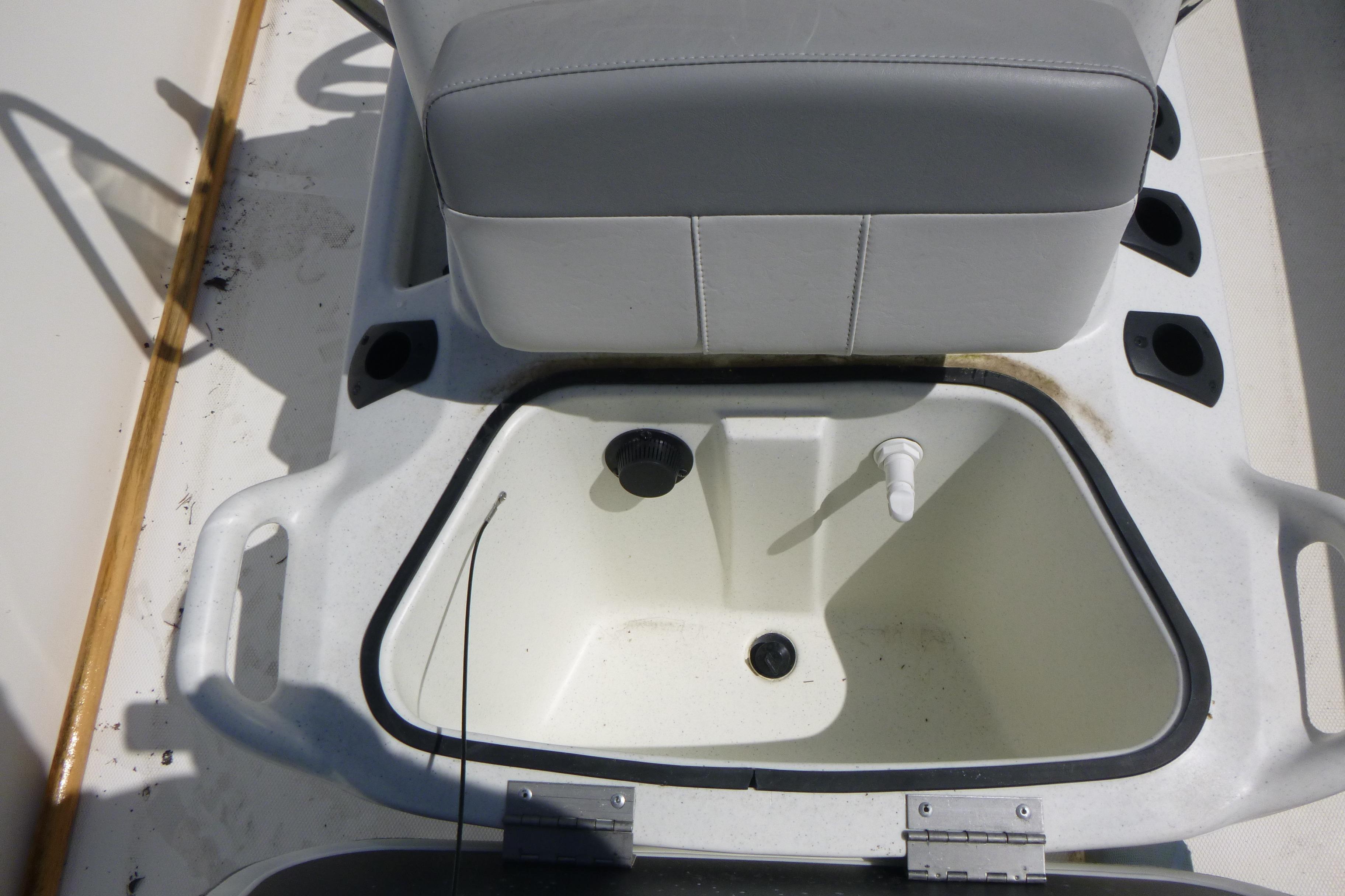 2024 Mako Pro Skiff 17 CC boat seat with integrated storage compartment.