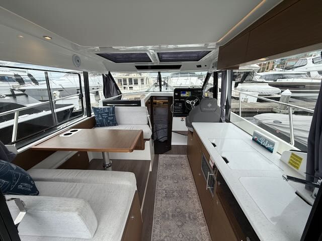 Interior of a 2021 Jeanneau NC 1095 with modern kitchen and seating area.