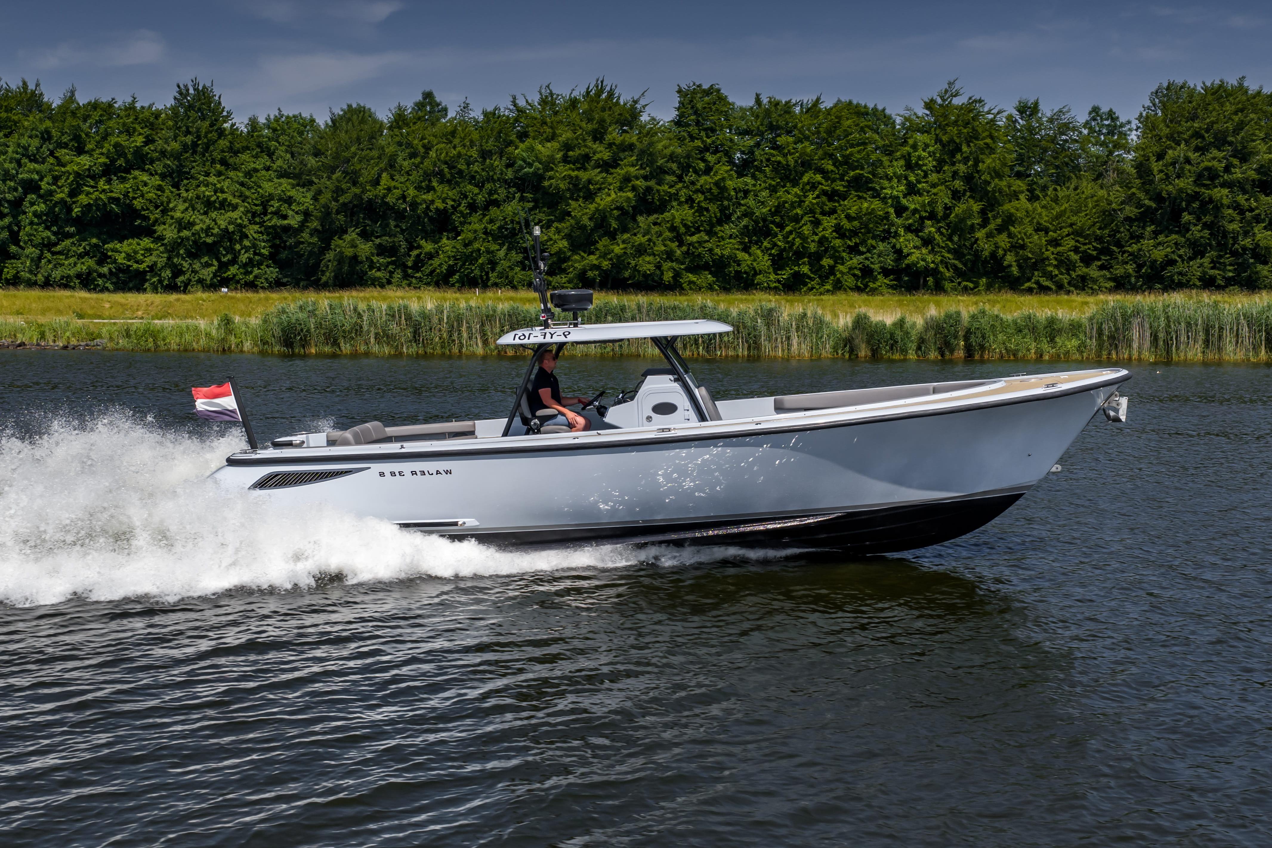 2017 Wajer 38 boat cruising on a scenic river with lush green trees.