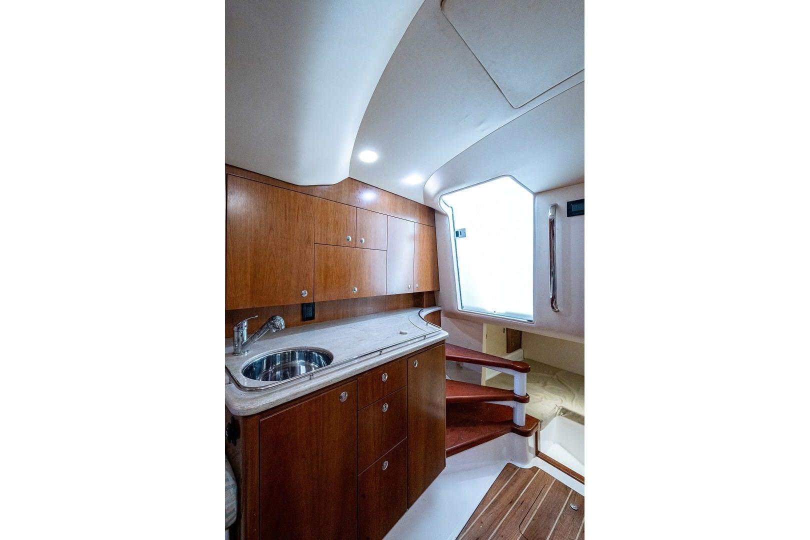 Luxurious interior of 2012 Brooks Boatworks 34, featuring wooden cabinetry and modern fixtures.
