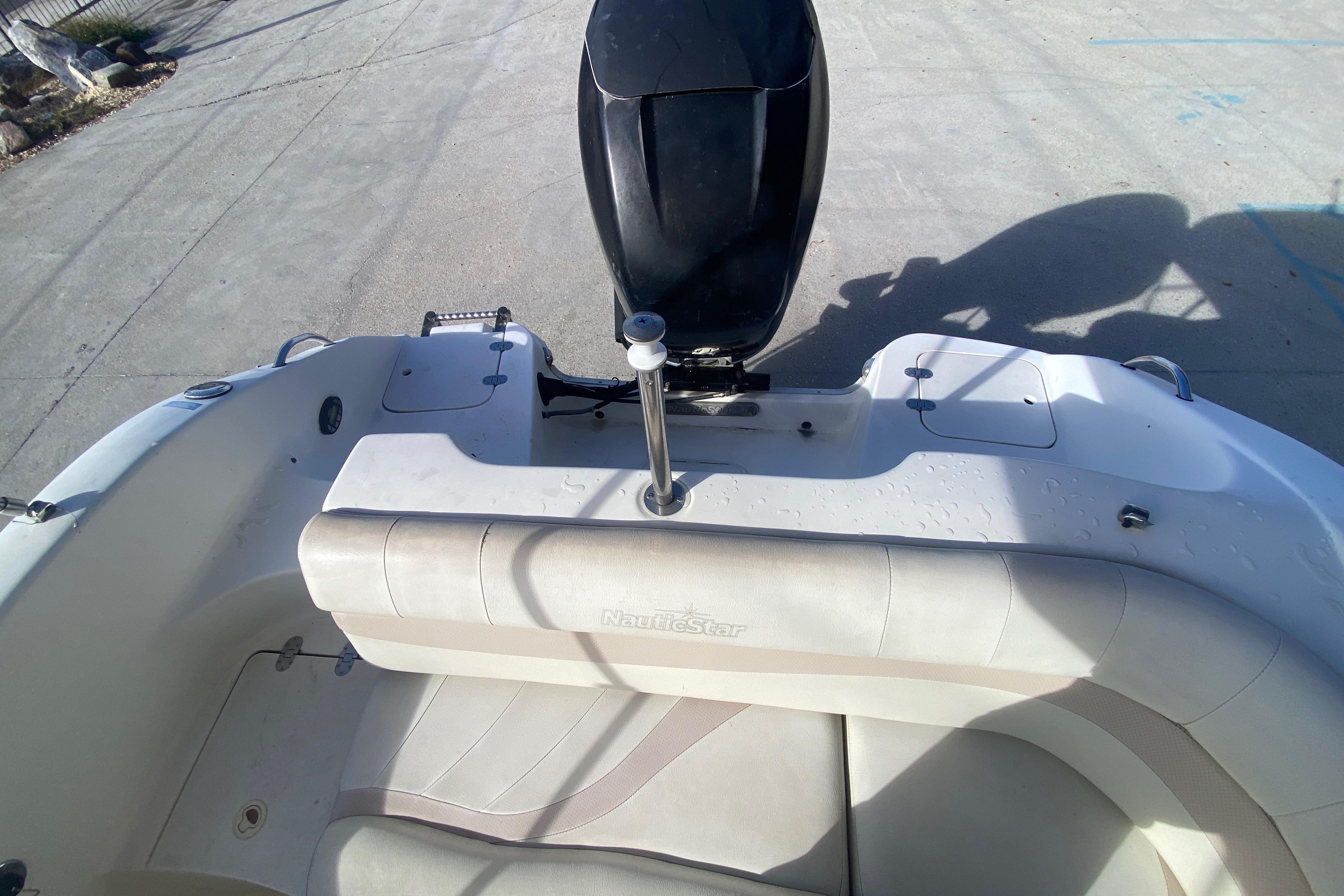 2007 NauticStar 230DC Sport Deck boat interior with seating and motor.