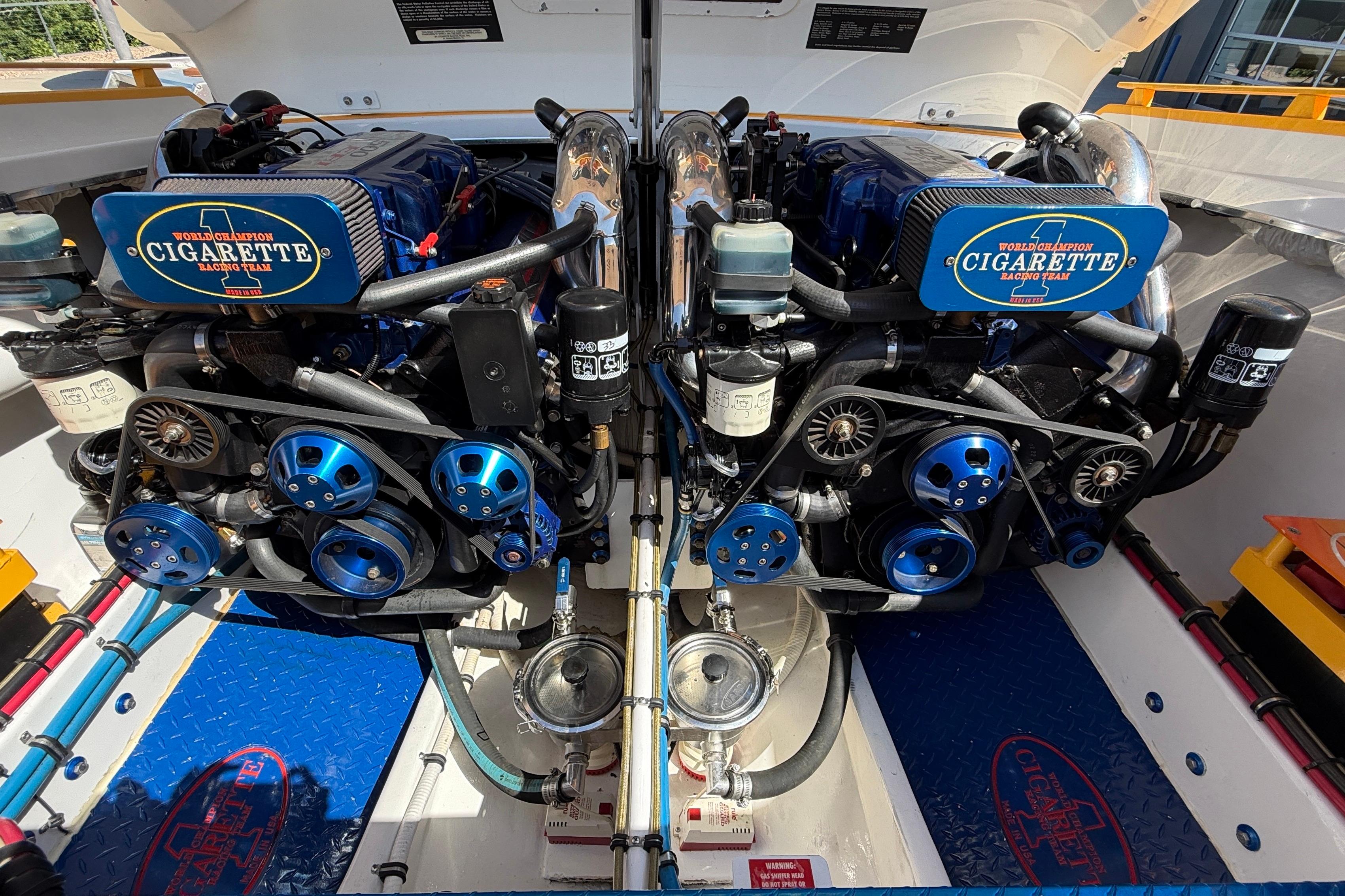 Twin engines of a 2002 Cigarette 35' Cafe Racer boat, showcasing detailed mechanics.