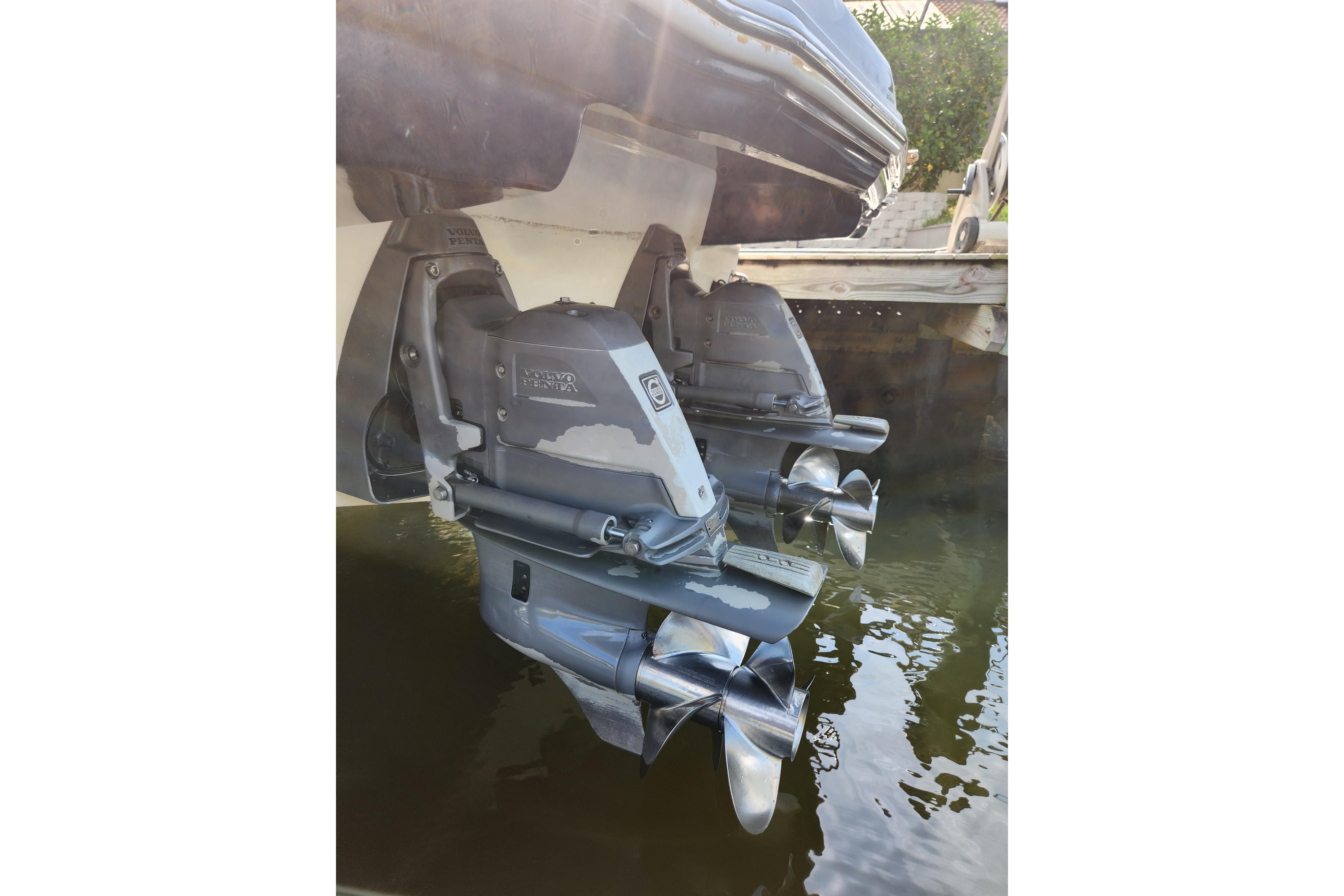 2012 Chaparral 310 Signature boat with dual Volvo Penta outdrives in water.