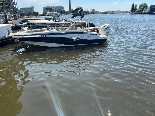 2020 Crownline E 205 XS boat docked on a sunny waterfront.