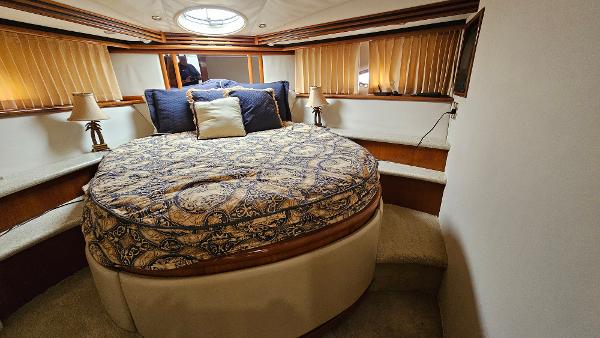Luxurious bedroom in 2000 Carver 450 Voyager Pilothouse yacht with elegant bedding.