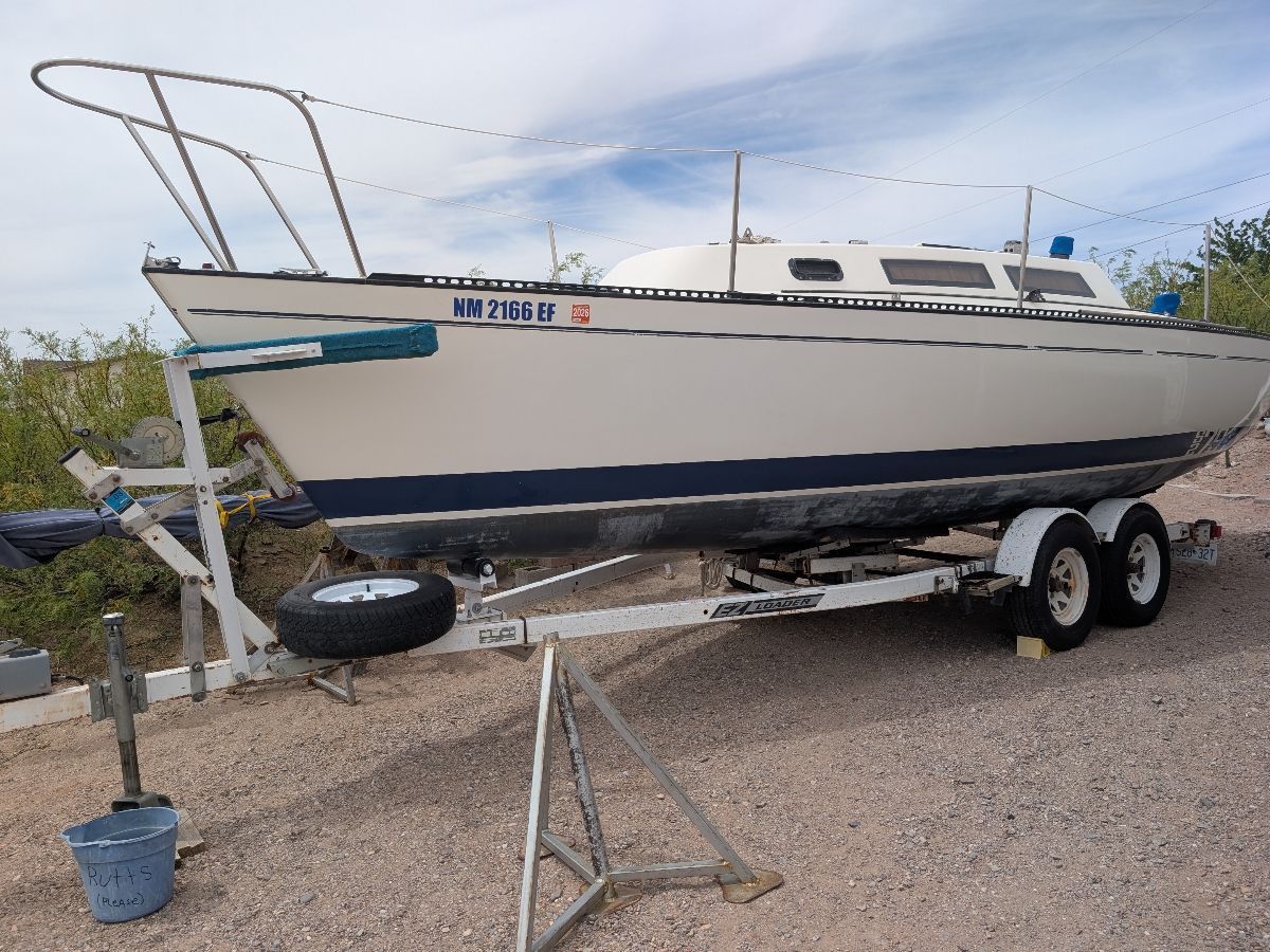 A sailboat on a trailer, ready for transport.