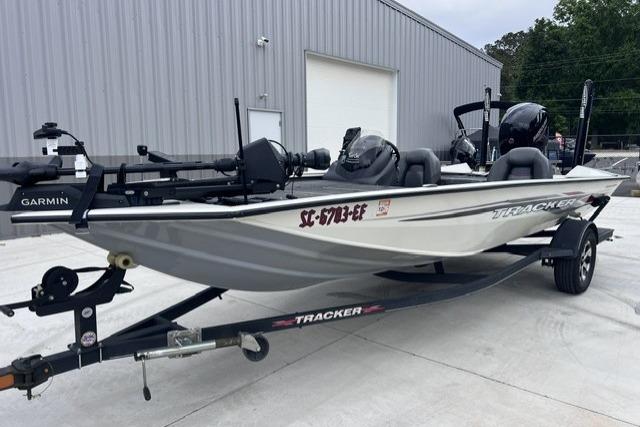 2021 Tracker Pro Team 195 TXW Tournament Edition boat on trailer, parked outside a building.