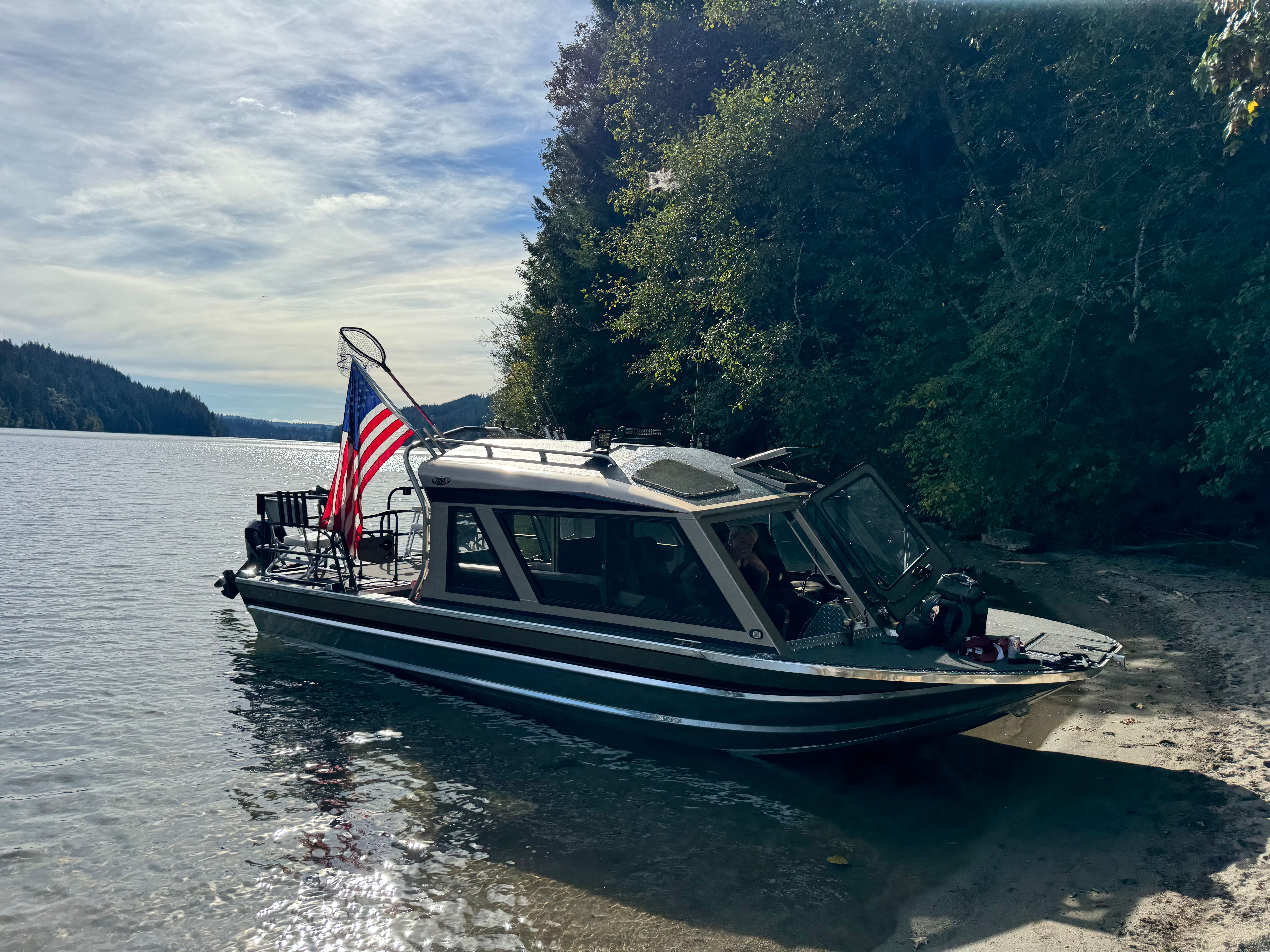 Custom RMX 24 boat on a serene lakeside, 2011 model.