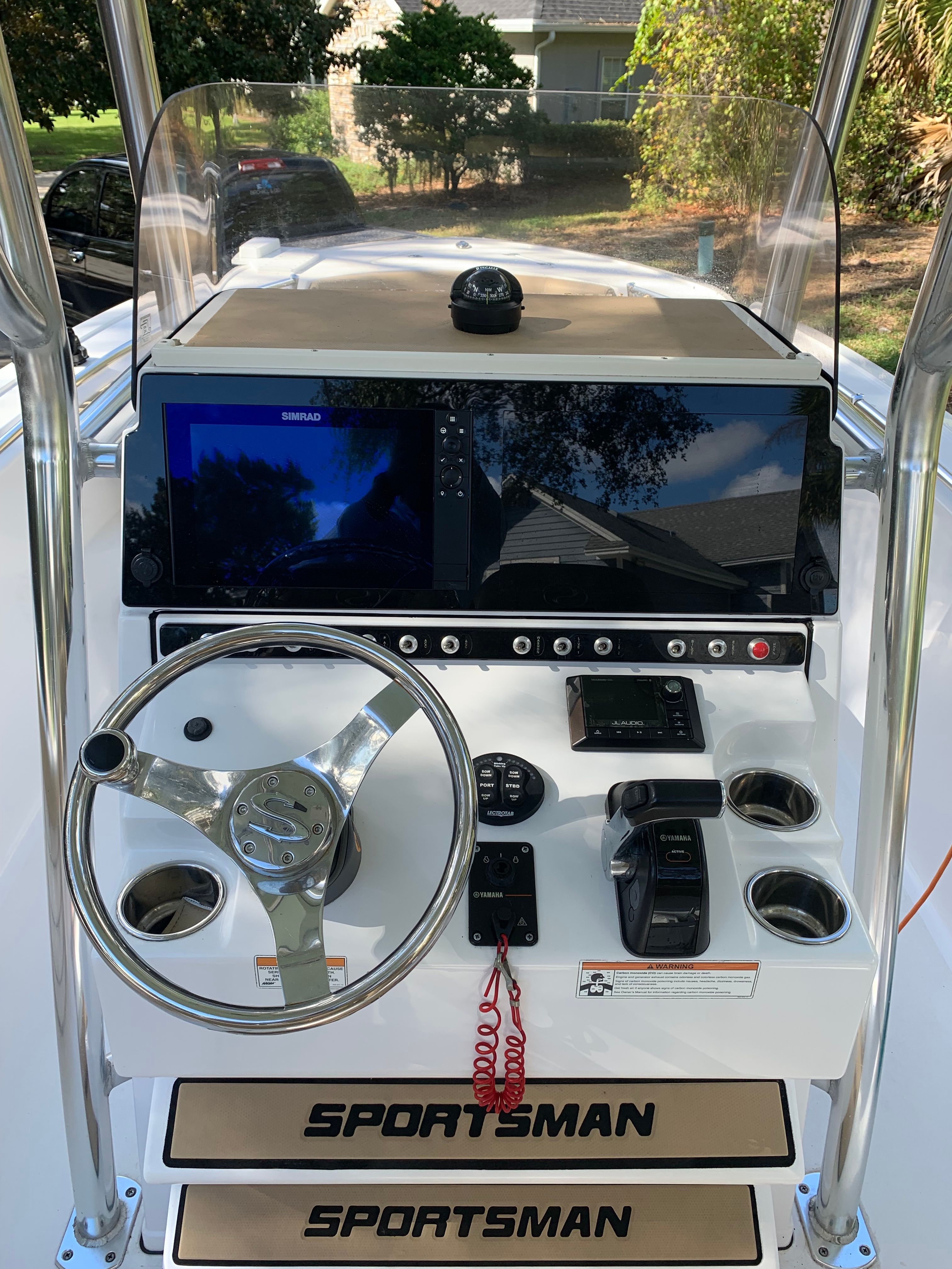 The image shows the helm of a 2018 Sportsman Heritage 241 Center Console boat.