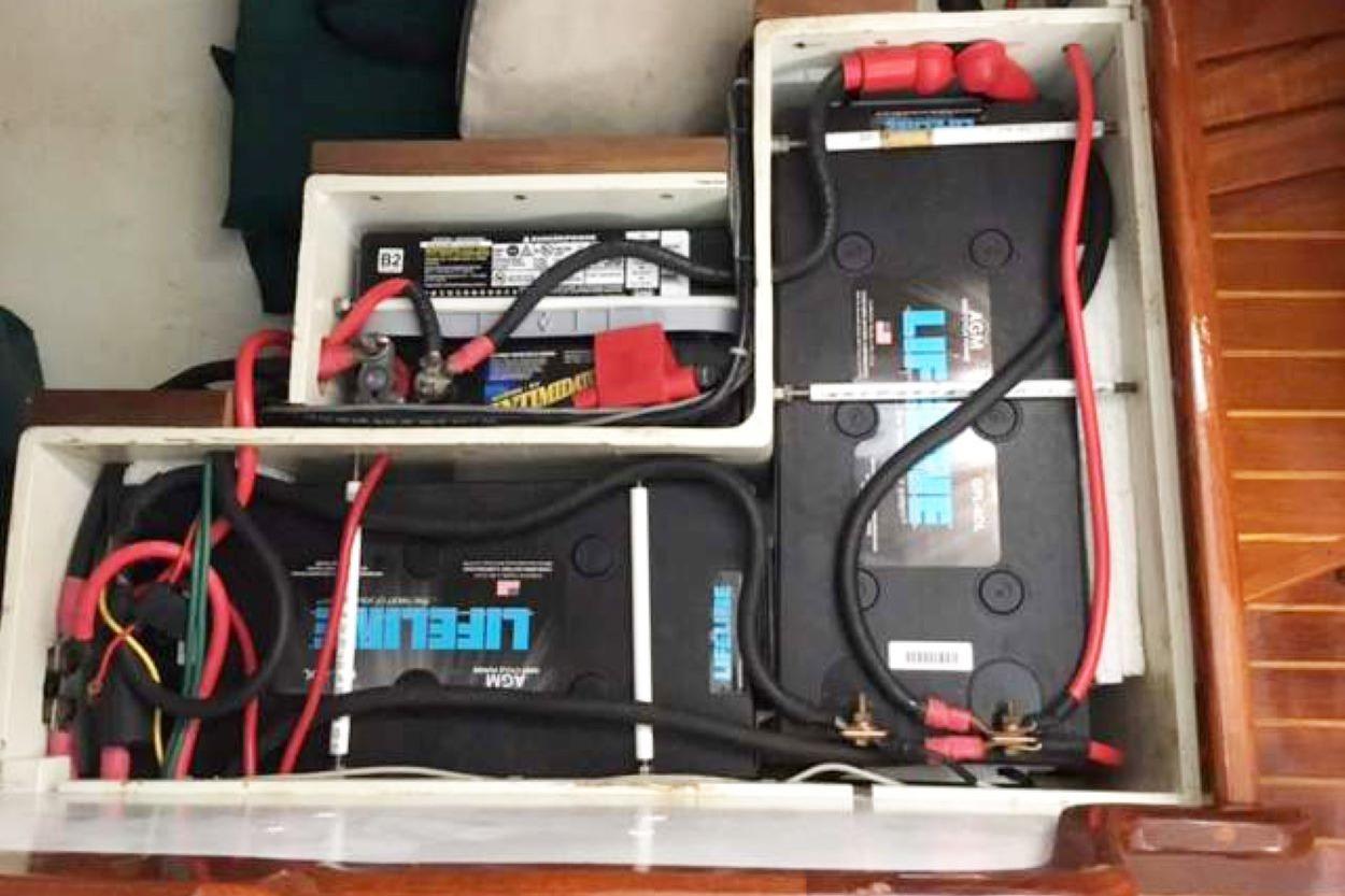Battery compartment of a 1981 Bristol Sloop, featuring Lifeline AGM batteries and wiring.