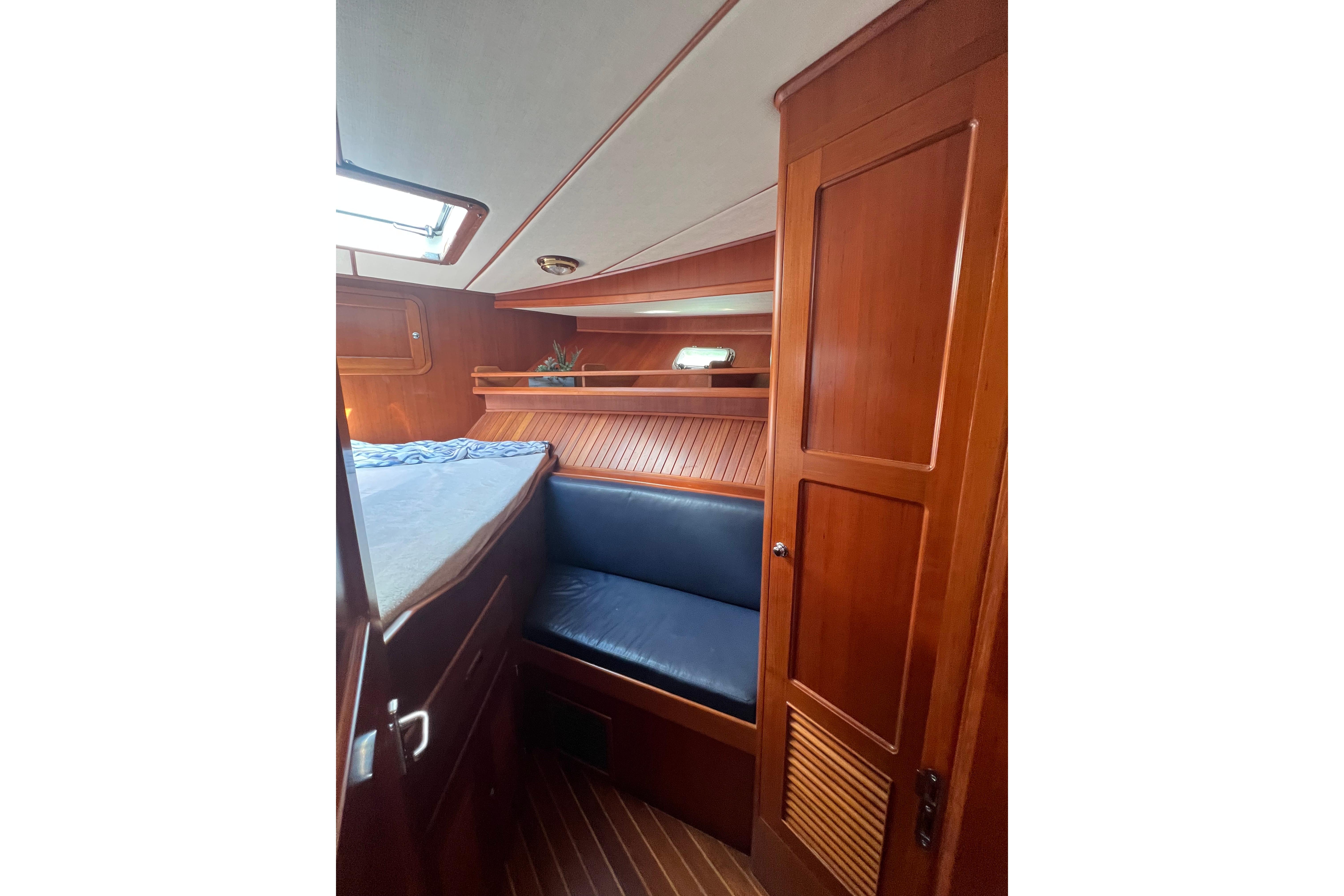 2007 Heritage East 36 Sundeck Trawler cabin with wood paneling and blue seating.