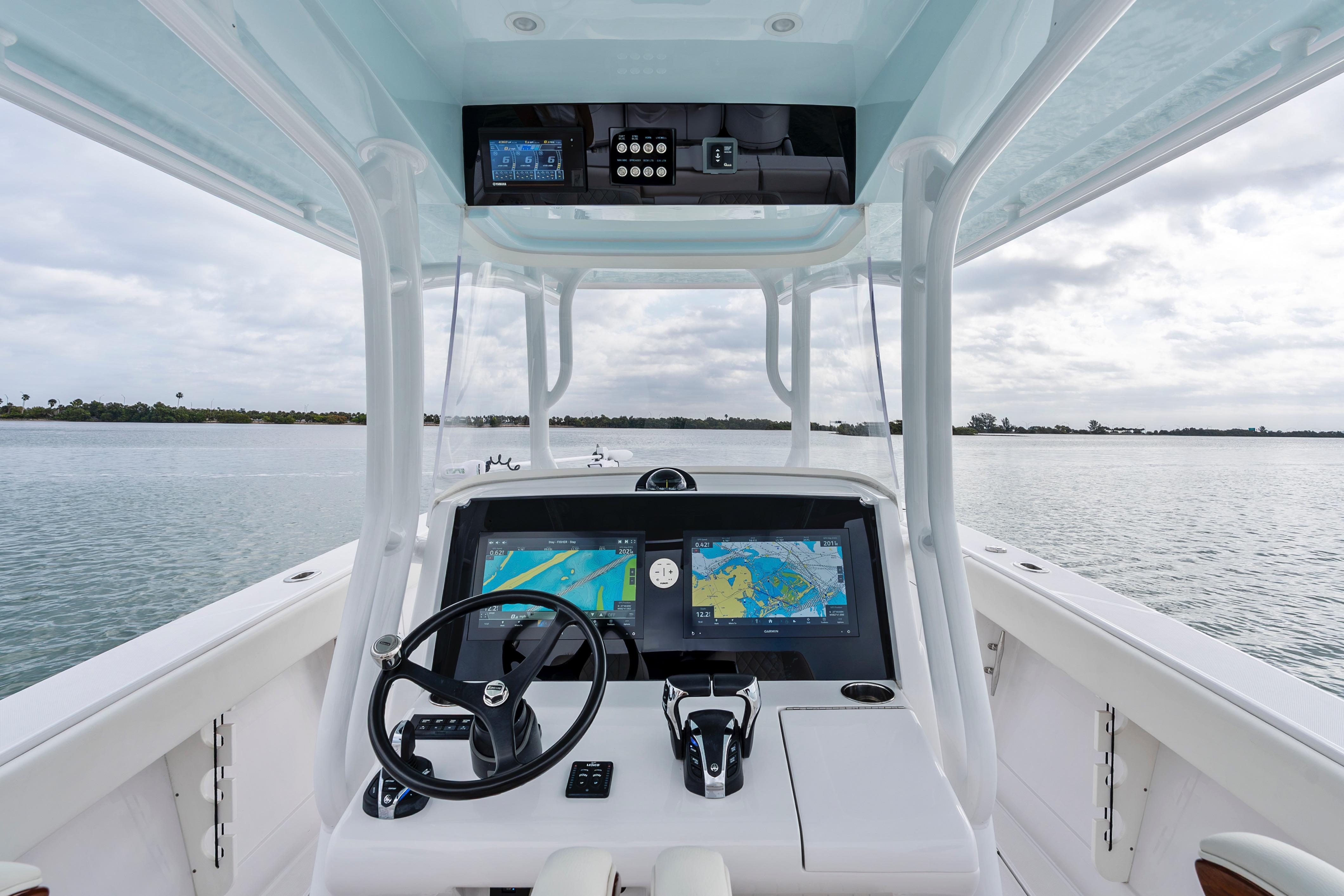 2022 Jupiter 34 HFS boat helm with dual navigation screens on calm water.
